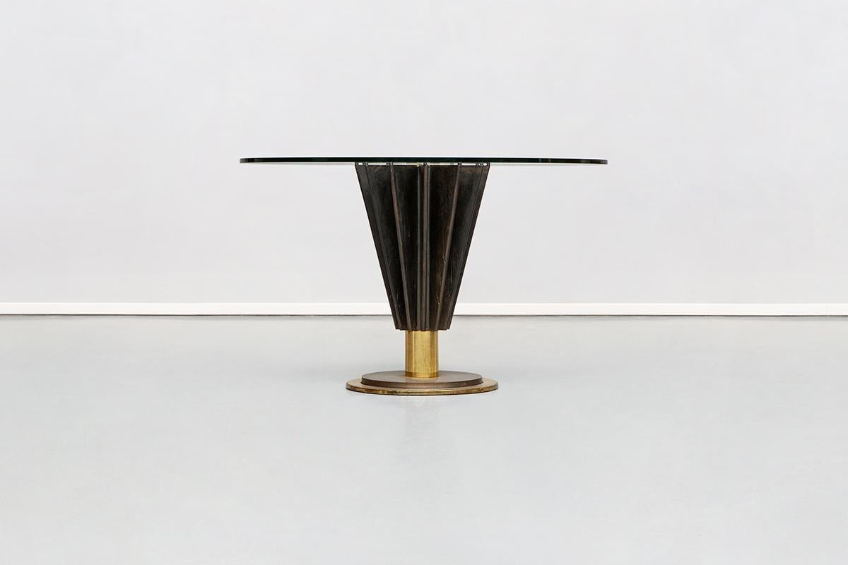 Round dining table by Pierre Cardin from 1980s
Unique and magnificent Pierre Cardin table from eighties. Absolutely rare production designed by Pierre Cardin in Italy. Structured in polished cast iron and brass with solid glass top. This piece