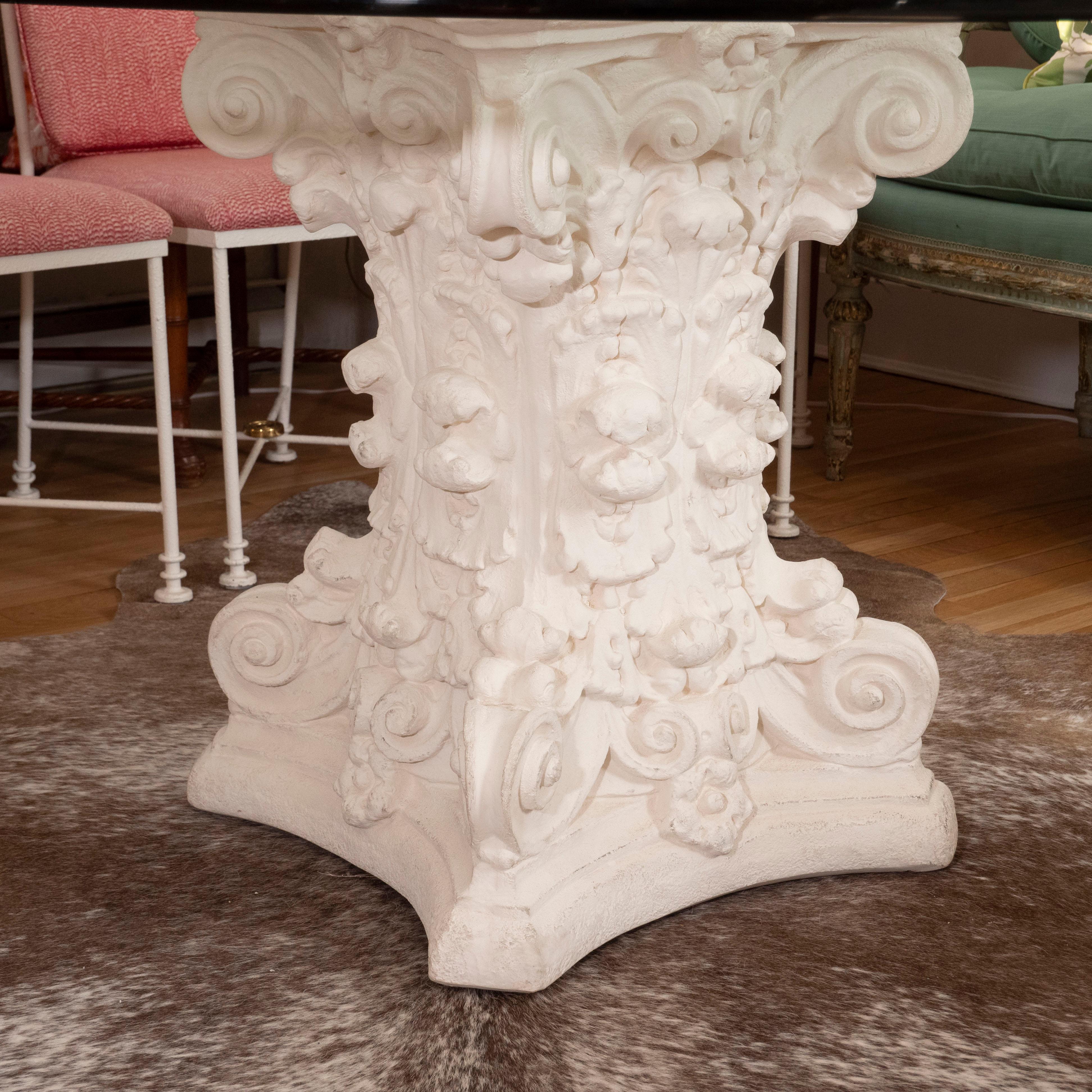 A spectacular dining table with a painted cast concrete sculptural base with a round beveled glass top. Light and airy, this table would look fabulous with either traditional or contemporary chairs.