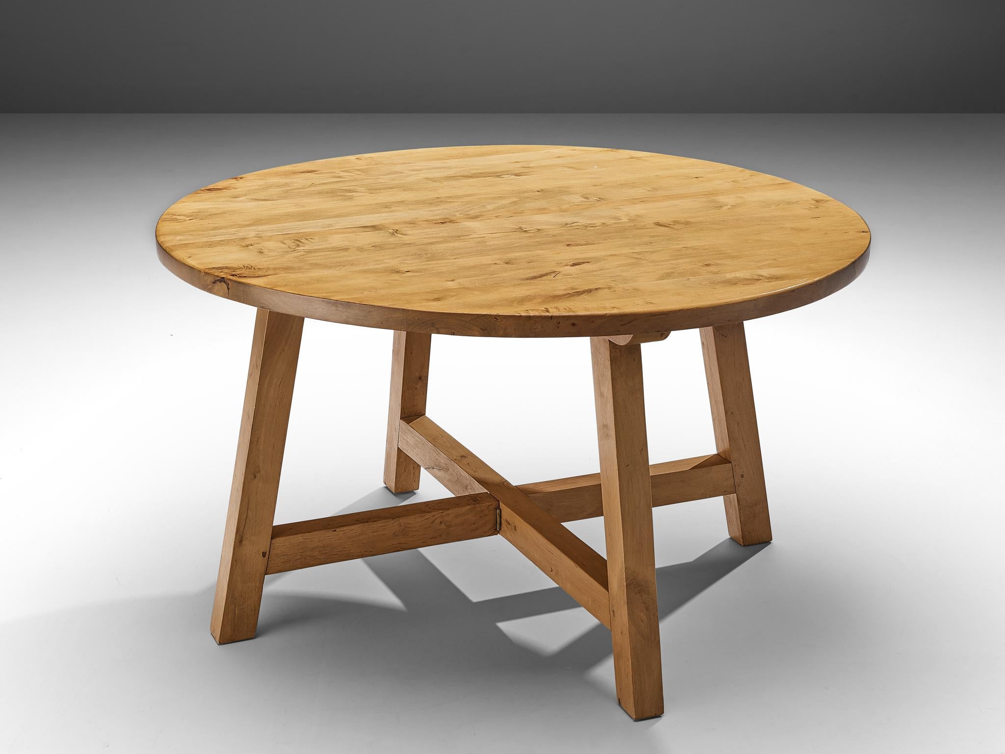 Round dining table, elm, Europe, 1960s.

This remarkable table holds a strong expression due to several aspects that are all typical for European Midcentury design. Firstly, the use of elmwood that holds a rural and robust aesthetic. Secondly, the