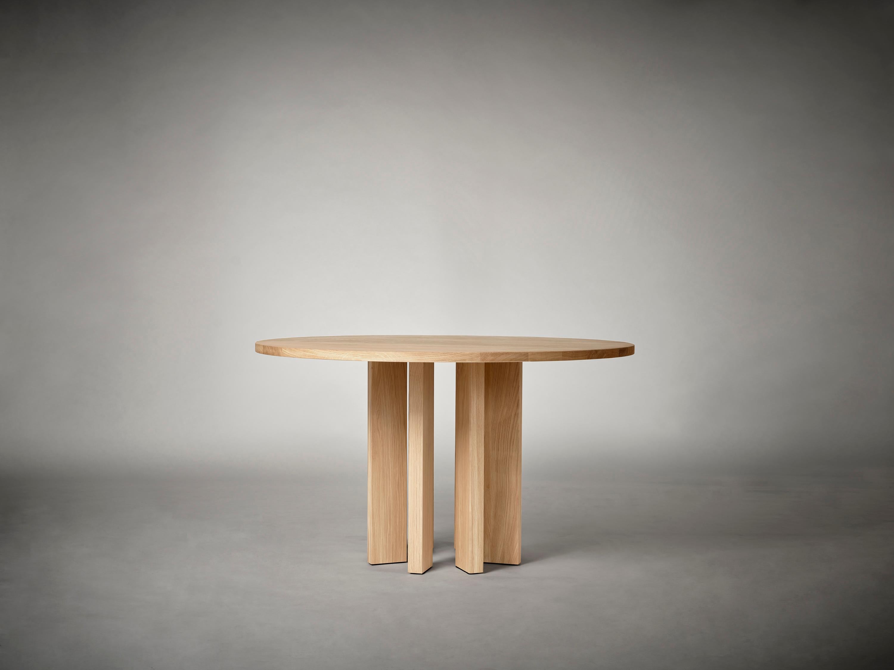 The vertical pillars of the Thola Table form a continuous circular base, creating a​ grounded yet dynamic architectural foundation. The Thola Table plays with light and shadow, creating a sense of quiet monumentality. Its vertical elements shift in