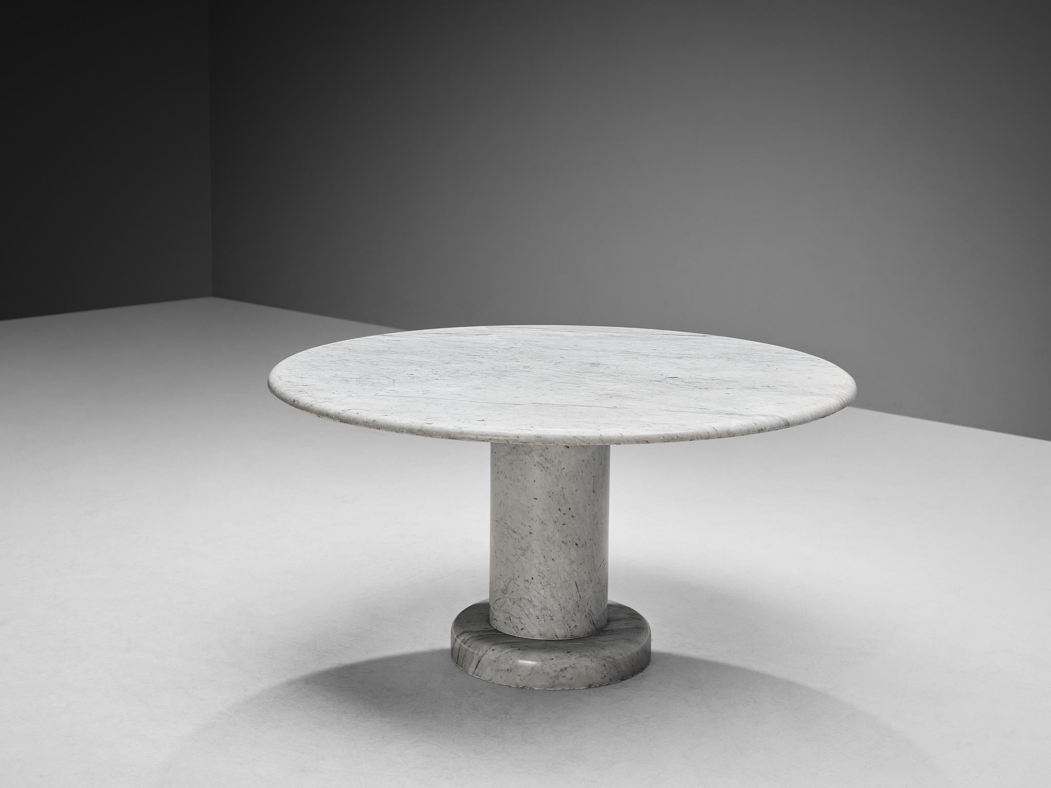 Round dining table, white marble, Italy, 1970s

This table is a skilful example of postmodern design and a great classic for versatile use. One solid marble pedestal, which is supported by a marble base, holds a minimalistic table top. The