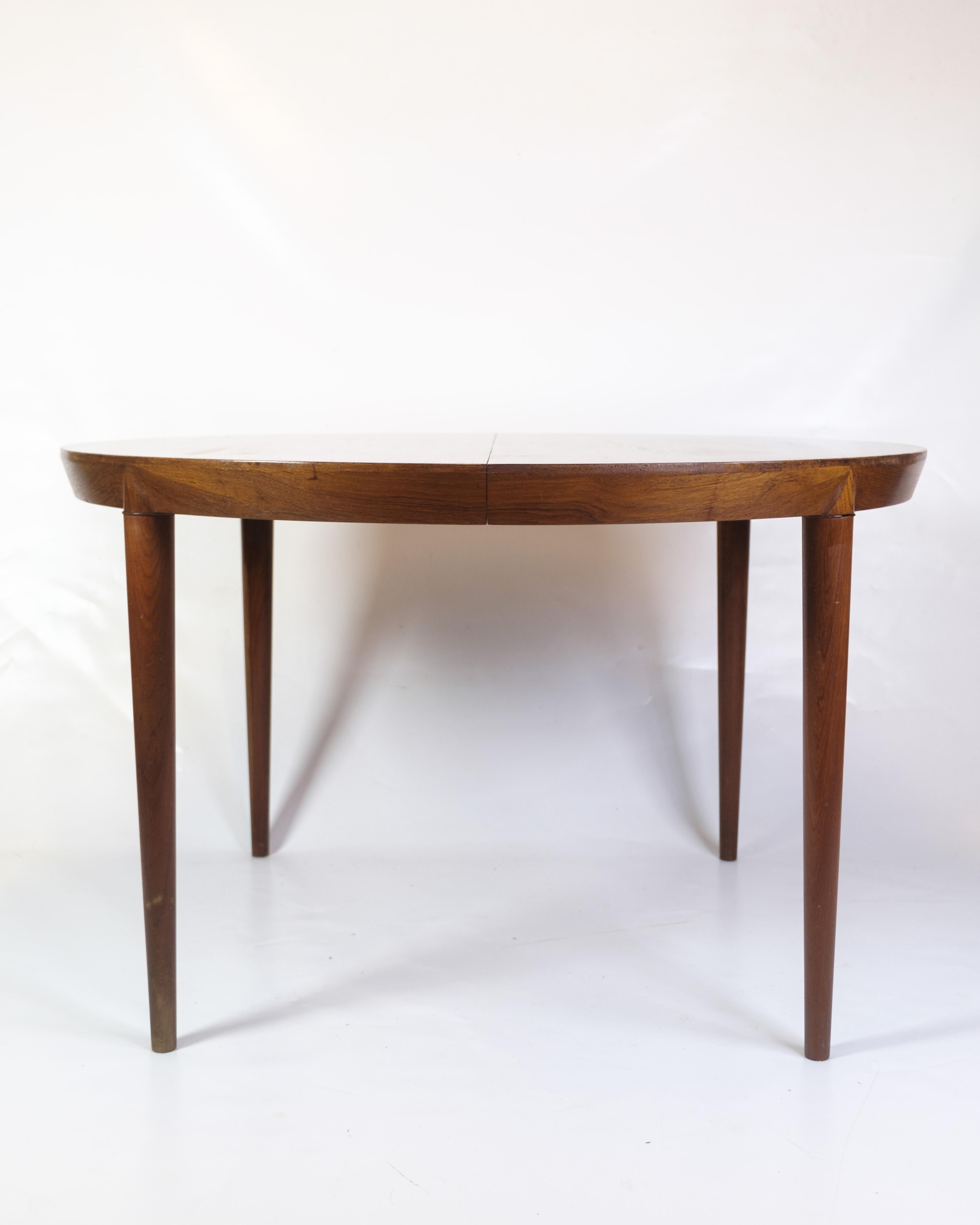 Round teak dining table designed by Severin Hansen in the 1960s and produced by Haslev Møbelsnedkeri. The table has the characteristic bevel joints and a simple design language that characterizes Hansen's design. It comes with extension leaves,