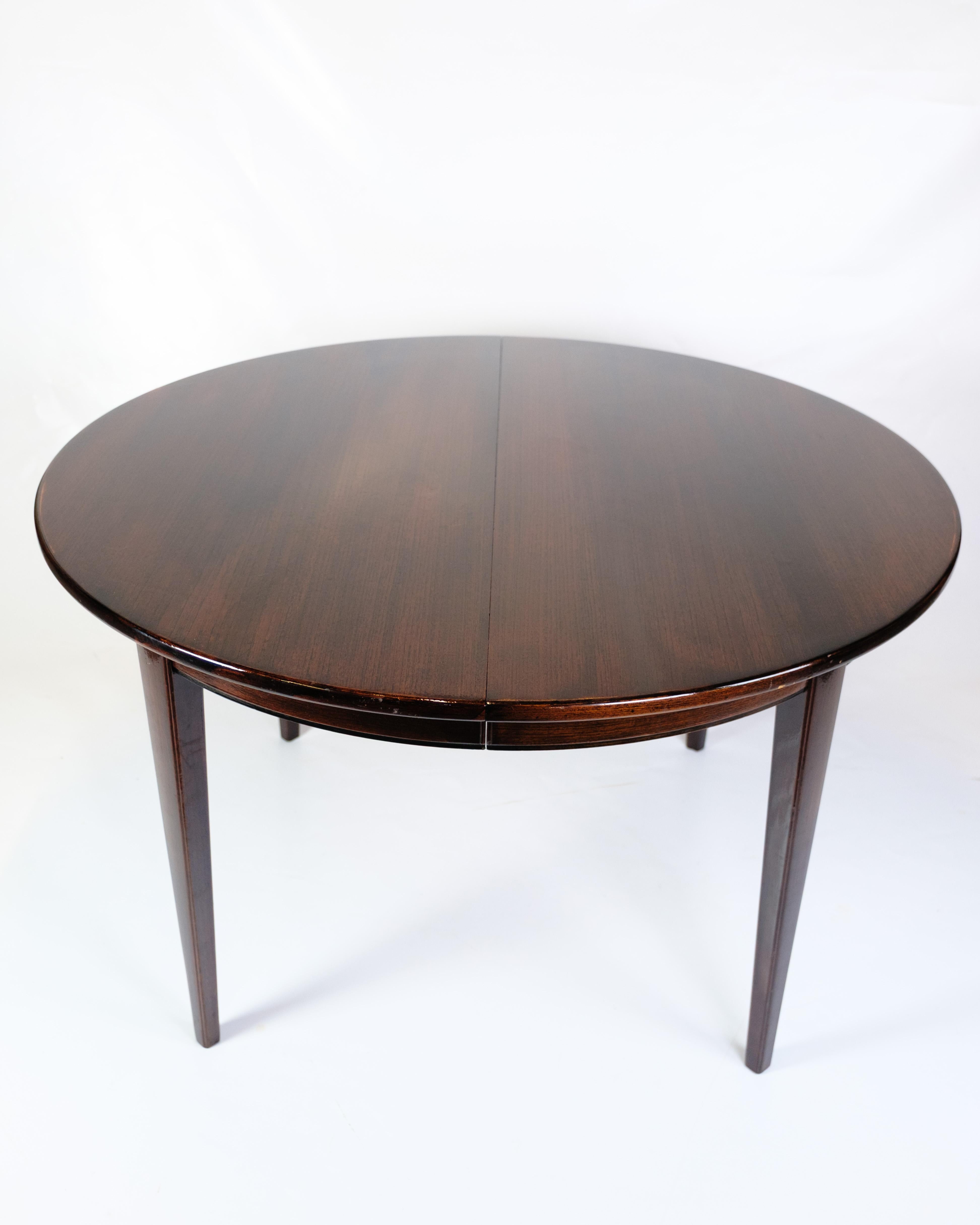 Round dining table, model 55, designed by Omann Junior in the 1960s. Made of mahogany with classic Danish design and focus on solid craftsmanship. The table comes with three extension leaves, which allows for flexible expansion, perfect for both