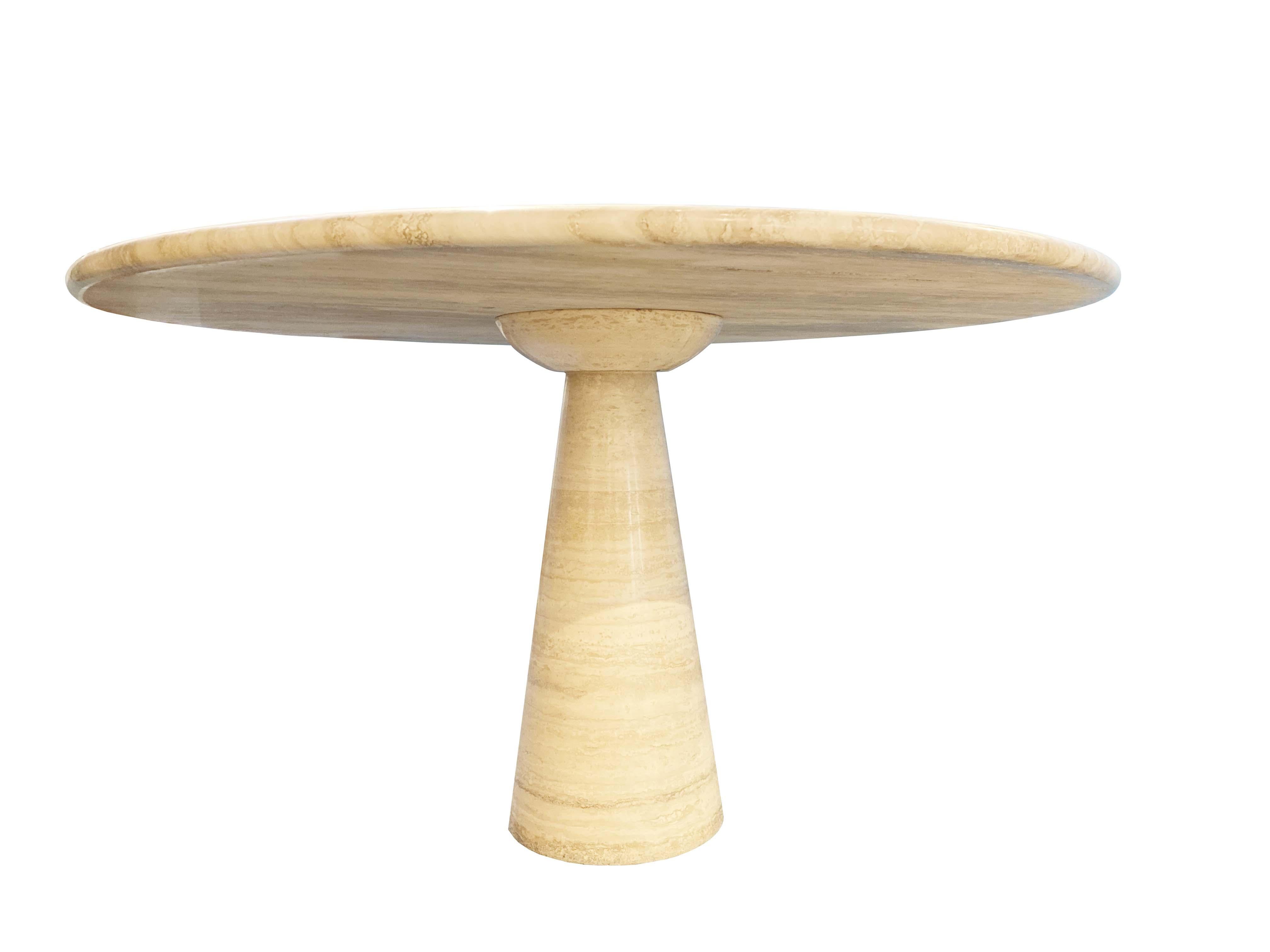 A round Italian travertine pedestal dining table, Italy, circa 1970s. 
Modern and minimalist design. Attributed to Angelo Mangiarotti. 

The marvel of this Italian table design is the top balances perfectly and securely by it's own weight.
Beautiful