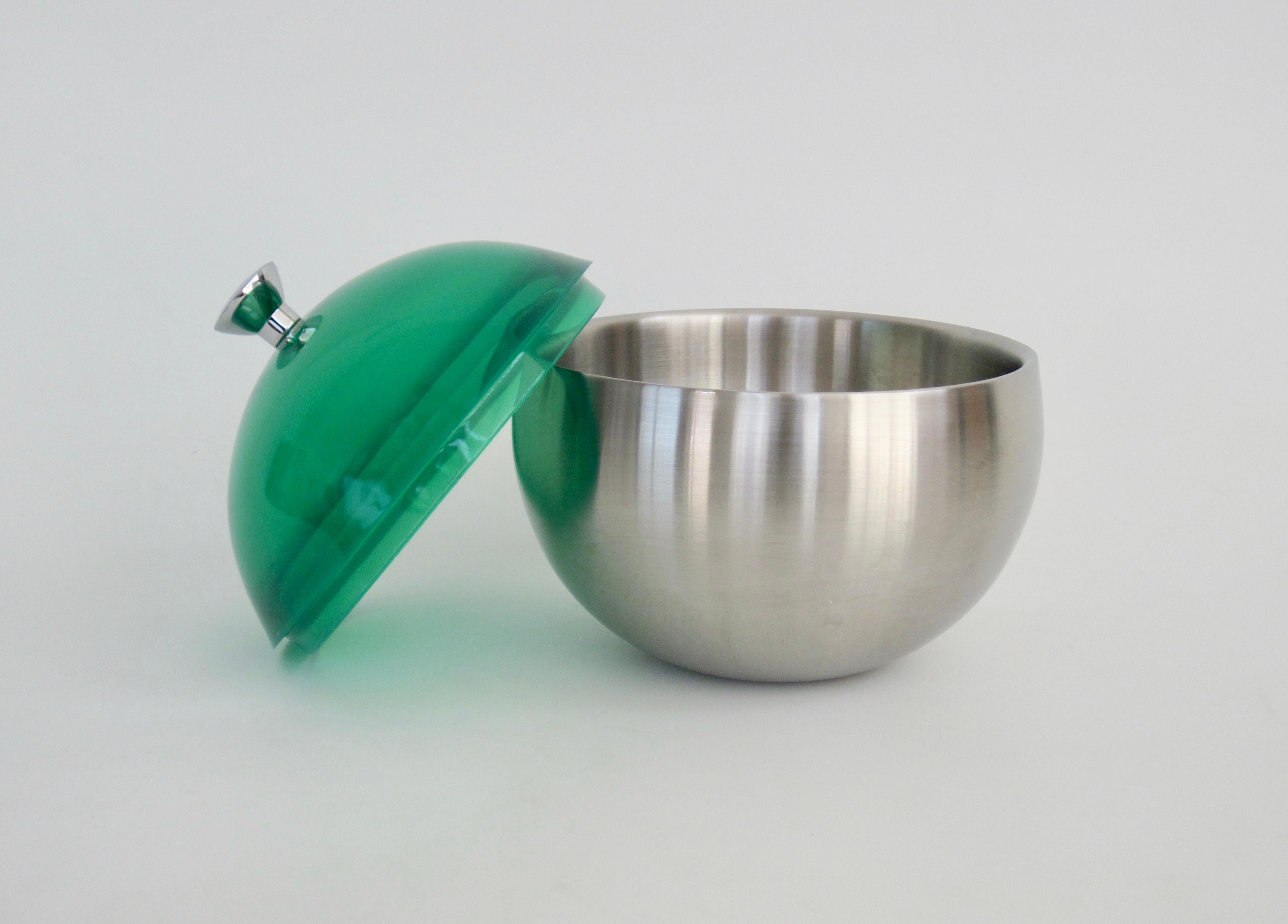 Orb shaped double wall stainless steel ice bucket and green lucite dome lid with knob handle Simplicity is what makes this a wonderful example of good design. The pop of color keeps it fun.