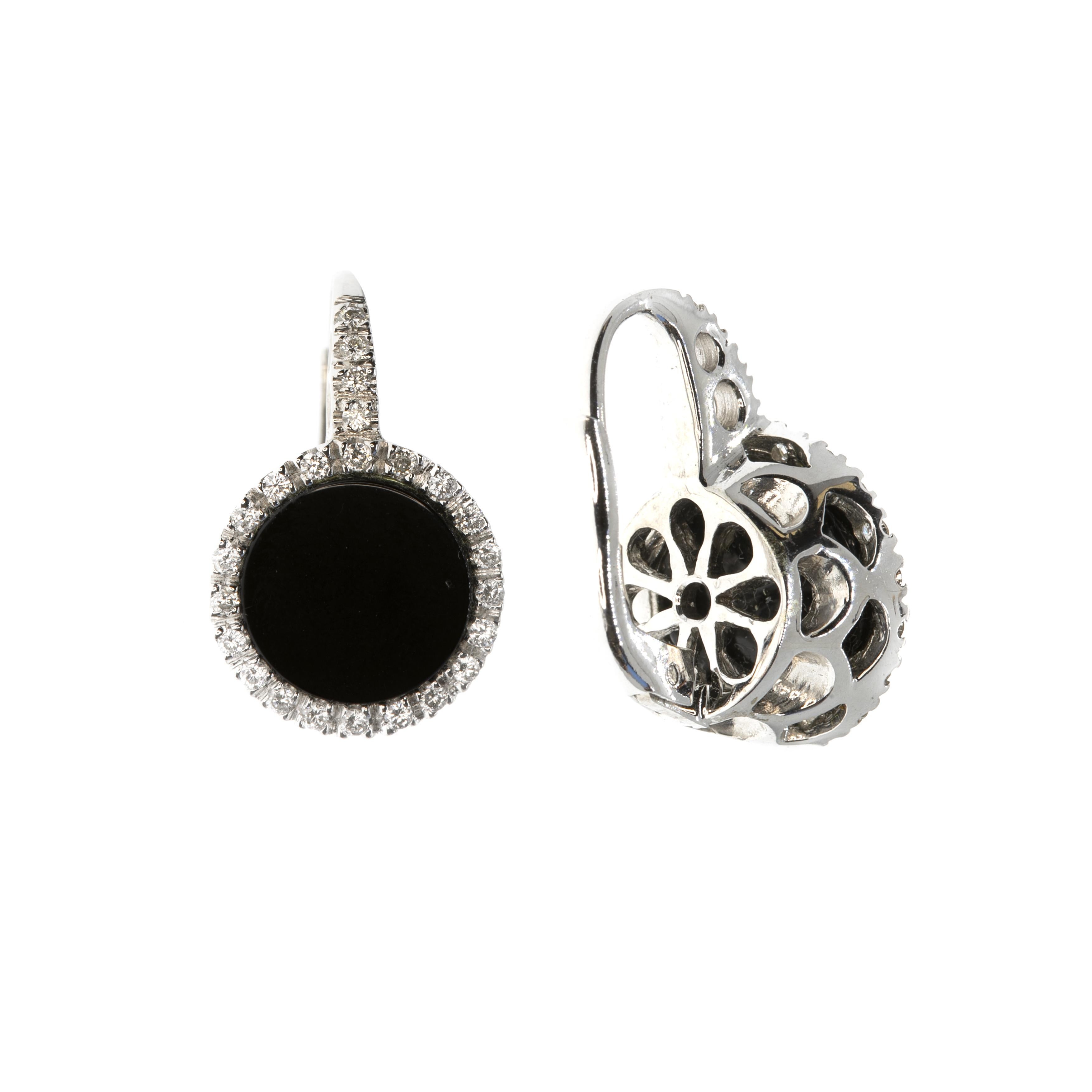 These earrings, masterfully created by hand from 18K white gold are each set with a large round onyx and a brilliant white diamond halo.

This is a delightful pair of earrings. They have bridge and spring clip backs and measure 13 mm across.