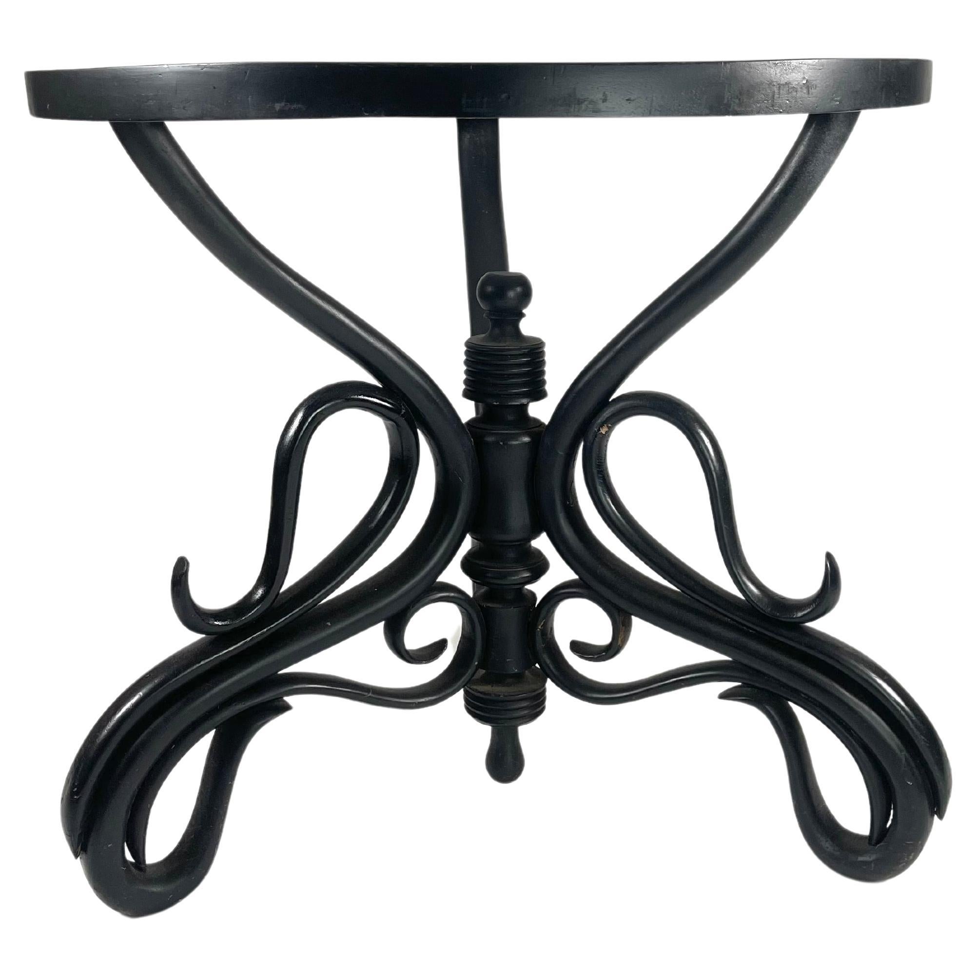 A round ebonized Thonet bentwood table with removeable green and gray marble top. The base is a wonderfully sculptural form with a fluid line and lightness that belies its great solidity and strength. This table would make a striking center table