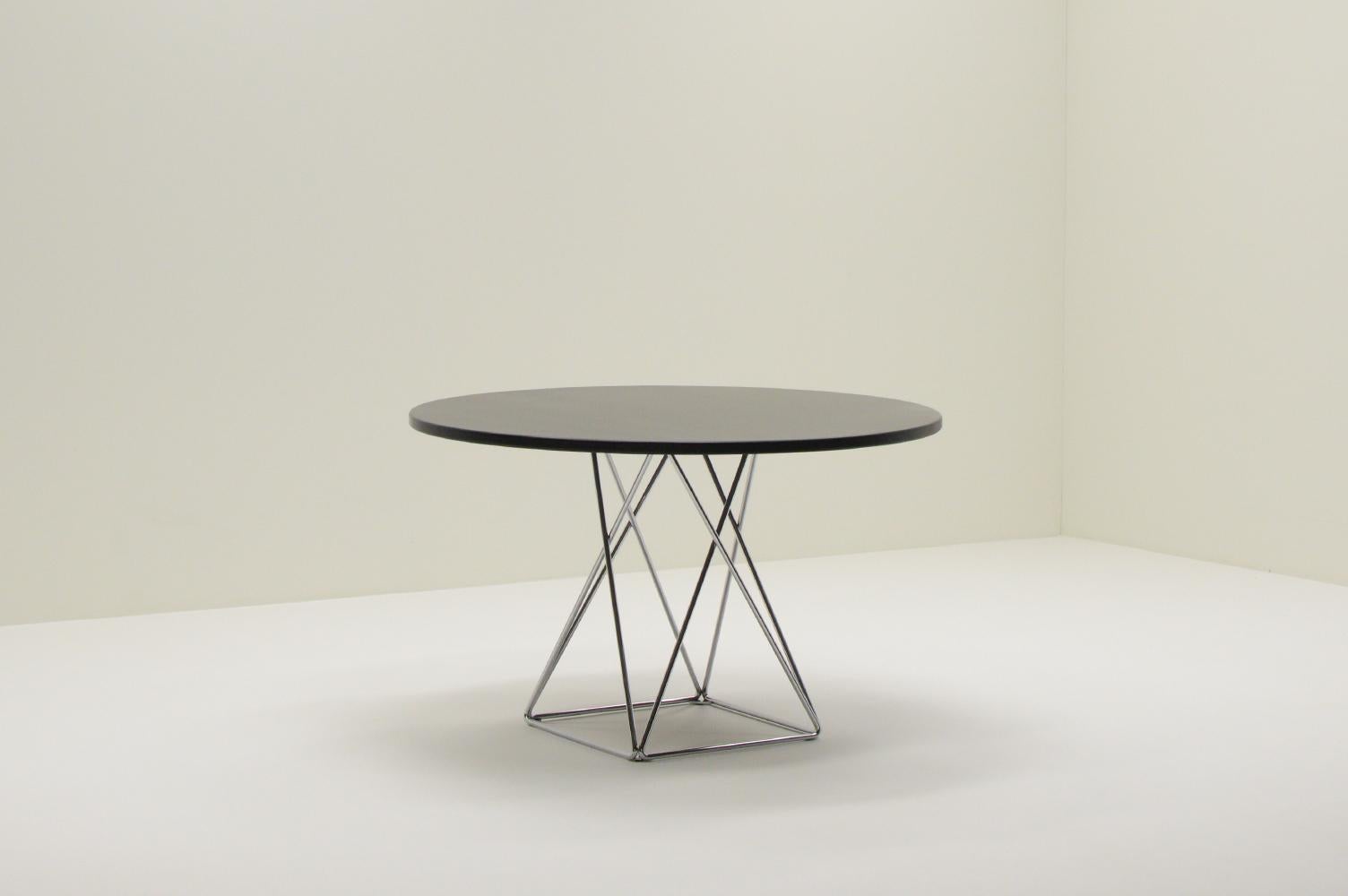 Round Eiffel dining table from Thonet, 1970s Germany. Chrome eiffel base and matt black top with light visable wood grain. The table is marked with the Thonet logo. The top has been refinished. Thonet furniture has been a part of the lives of many