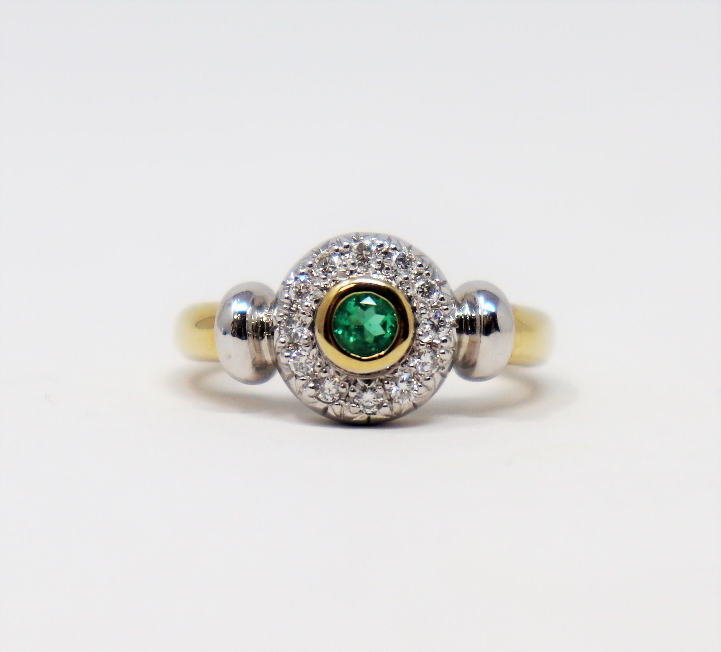 Ring size: 5.25

This contemporary band ring dazzles with understated elegance. The bright green natural emerald is nestled among a sparkling pave halo of diamonds, while the polished two tone metal creates a modern aesthetic. 

This beautiful ring