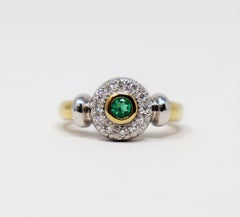 Round Emerald Bezel Set and Pave Diamond Halo Ring in Two Tone 14 Karat Gold