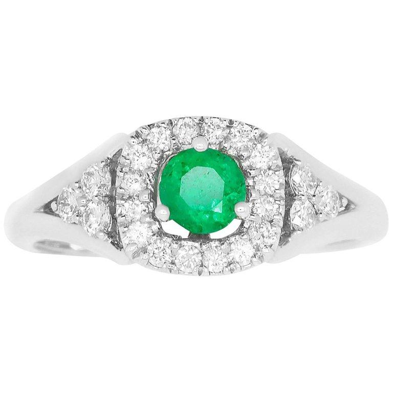 Material: 14k White Gold
Gemstones: 1 Round Cut Emerald at 0.26 Carats. 
Diamonds: 22 Brilliant Round White Diamonds at 0.33 Carats. Clarity SI. Color: H-I.
Ring Size: 6.75. Alberto offers complimentary sizing on all rings.

Fine one-of-a kind