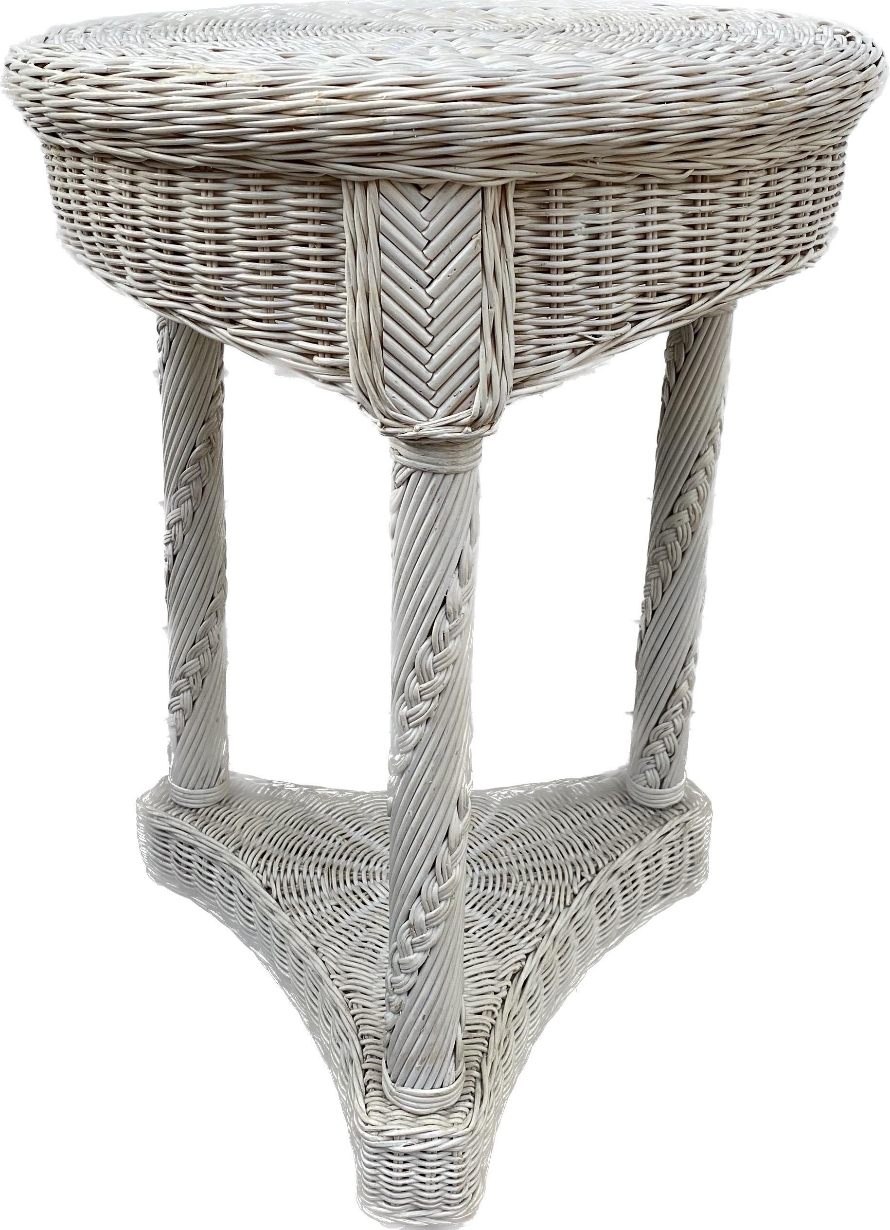 Round Empire style white painted woven wicker accent side or end table featuring a three-column base with braided twist decorations.