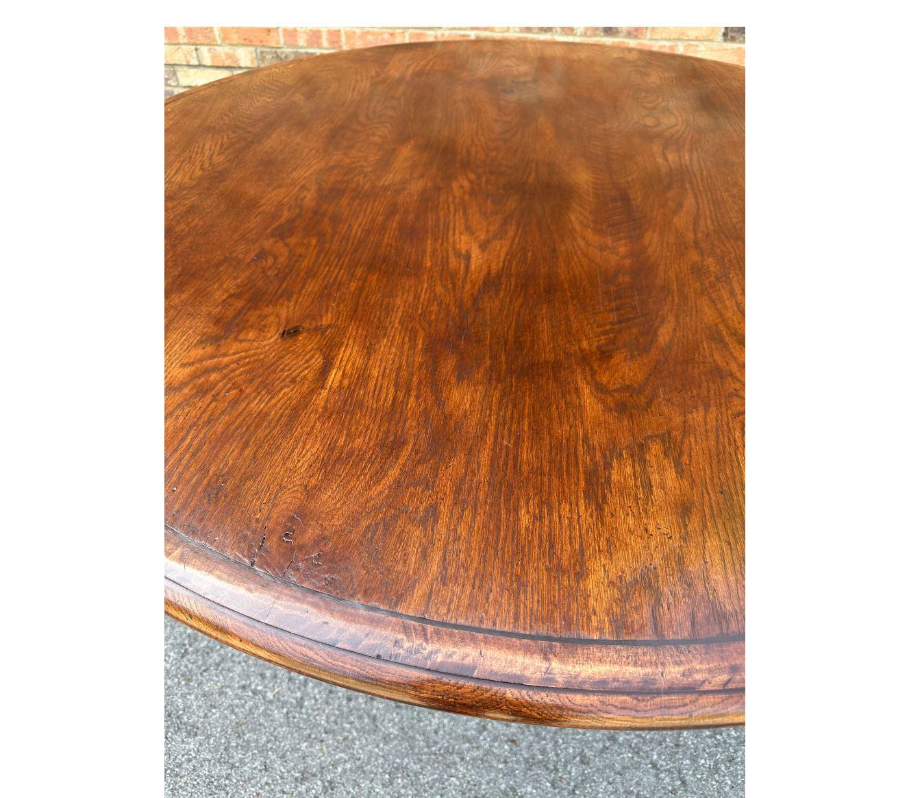 This is a beautiful custom-made dining table from England! The wood has lovely natural designs and is a gorgeous warm tone. Very simple, yet elegant design with round top and pedestal base. This table would make an excellent addition to your dining