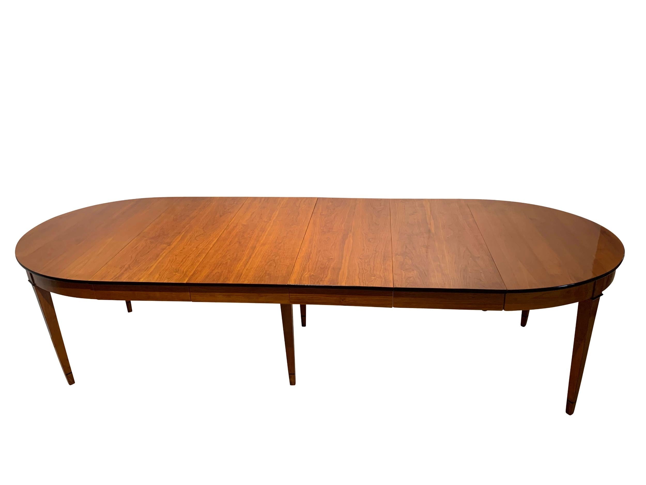 Round expandable dining table, cherry wood, France, Paris circa 1880.

Lovely bright Cherry veneer and solid wood. Refinished and hand-polished with shellac. Straight, conical square legs with ebonized rings. The side of the plate has been