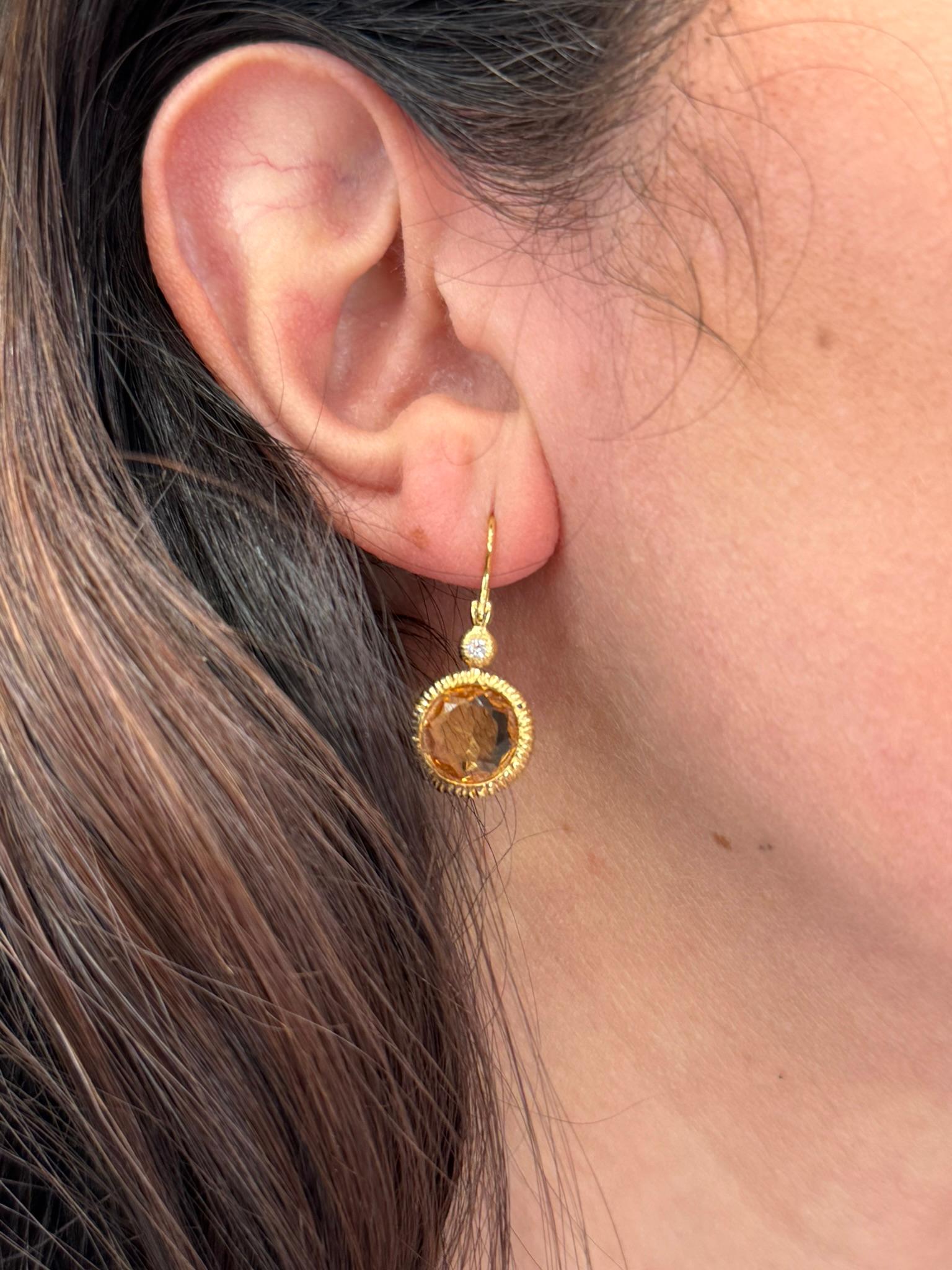 14K yellow gold drop earrings with two round faceted citrines that are bezel set and two round brilliant cut diamonds weighing 0.06 carat total. 

- Diamonds are G/H color, VS clarity.