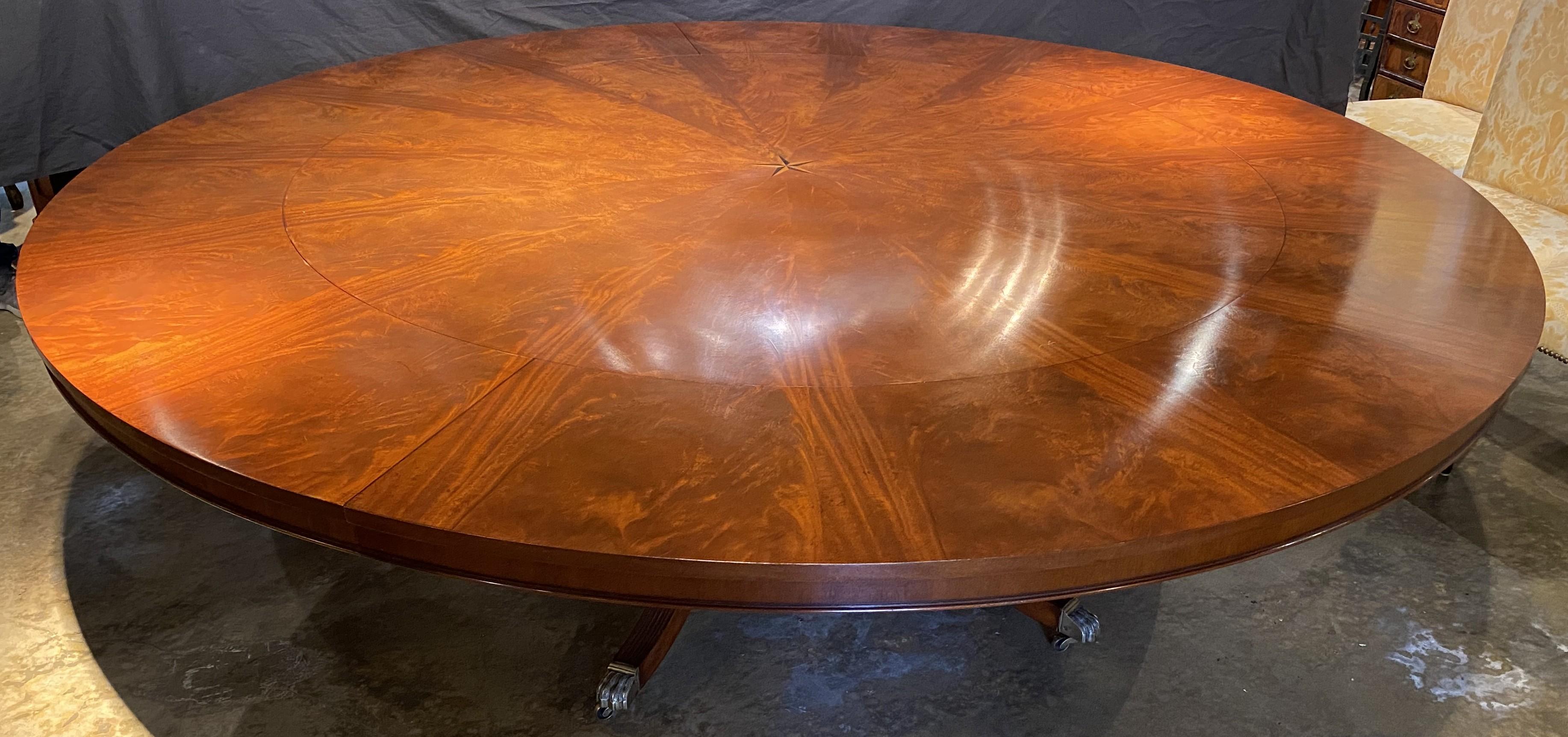 Hand-Carved Round Figured Mahogany Jupe Style Dining Table with Five Leaves and Star Inlay For Sale
