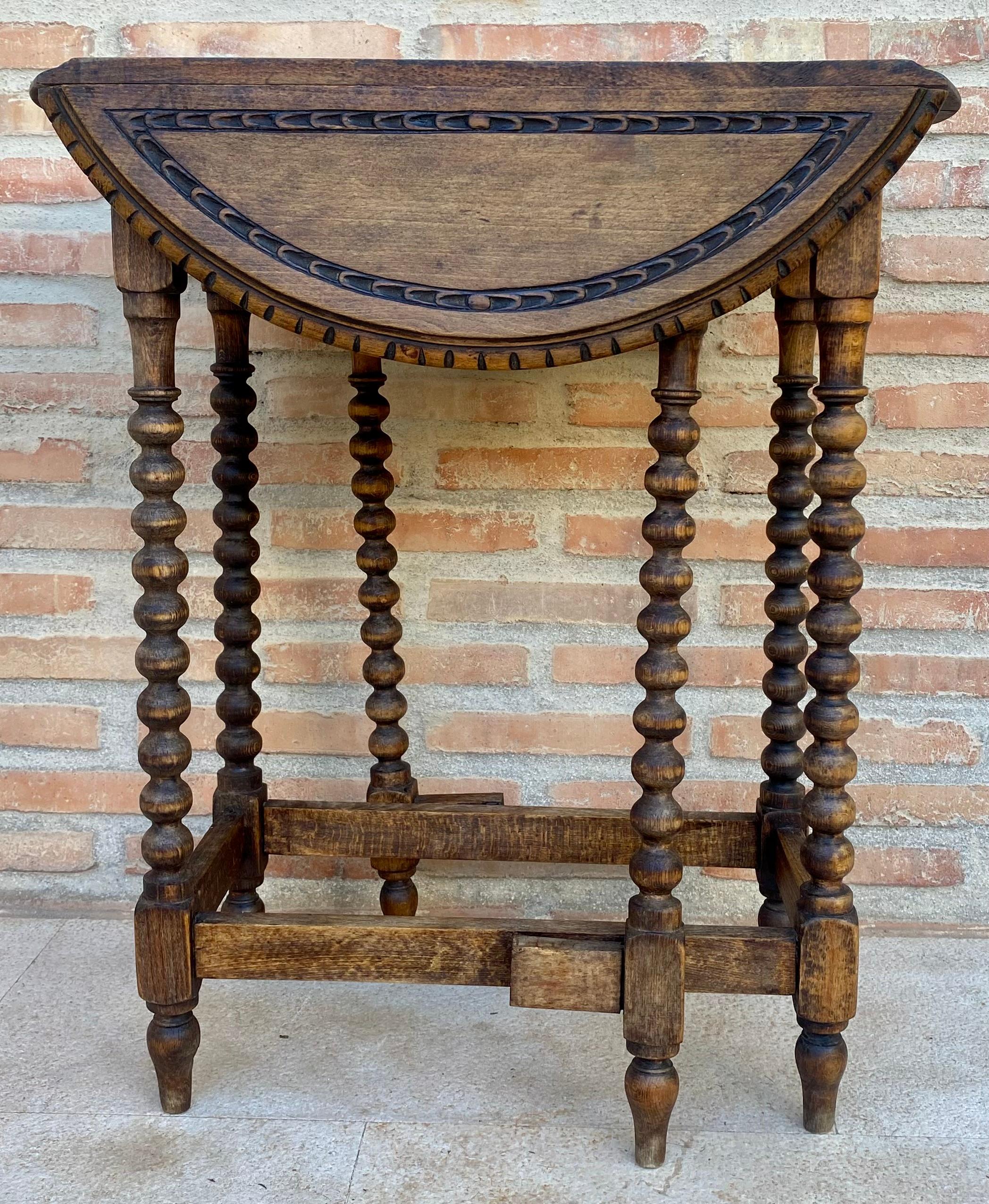 Round Folding oak side table with Solomonic legs and carved top and carved edges. The table has six legs when its opened with stretchers between the legs to reinforce the stability .
Restored and very functional piece.