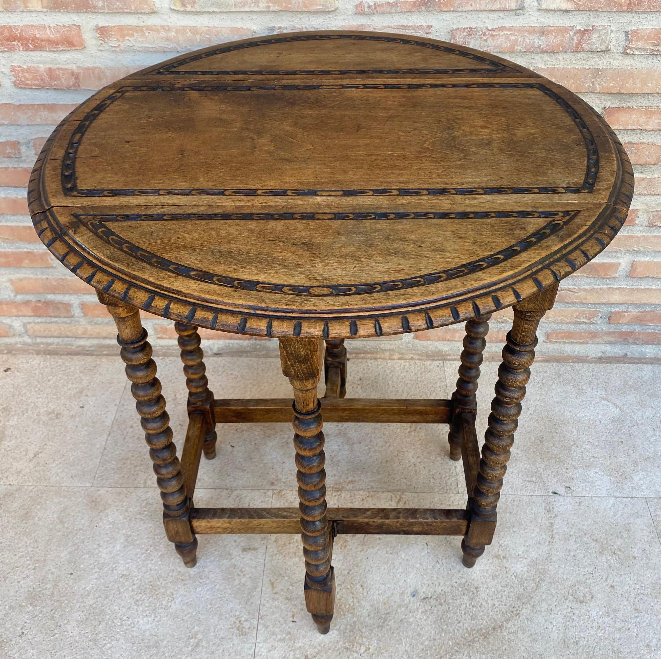 Spanish Round Folding Center Oak Table with Carved Top and Solomonic Legs, 1940s