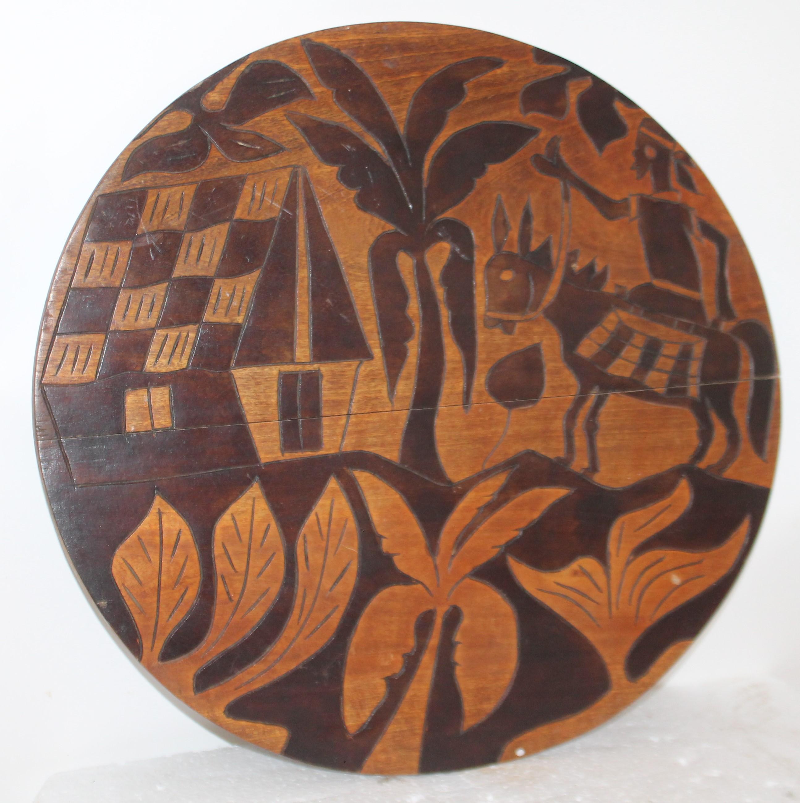 This folky handmade and inlaid round game board was made in Haiti in the mid-20th century. It is reversible and in good condition.