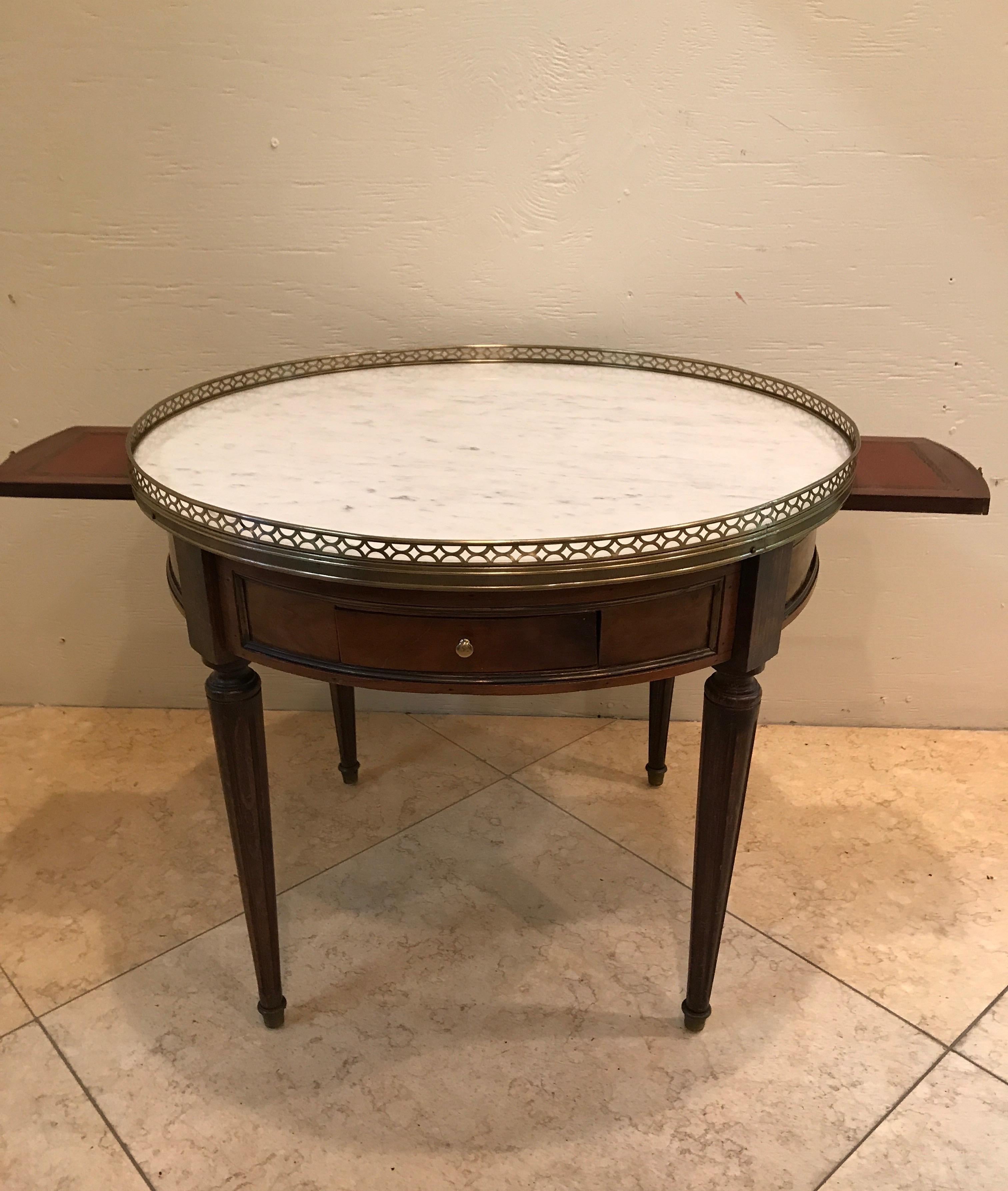 French Bouillotte cocktail table with two drawers and two pullout extensions. A brass gallery surrounds the marble top.