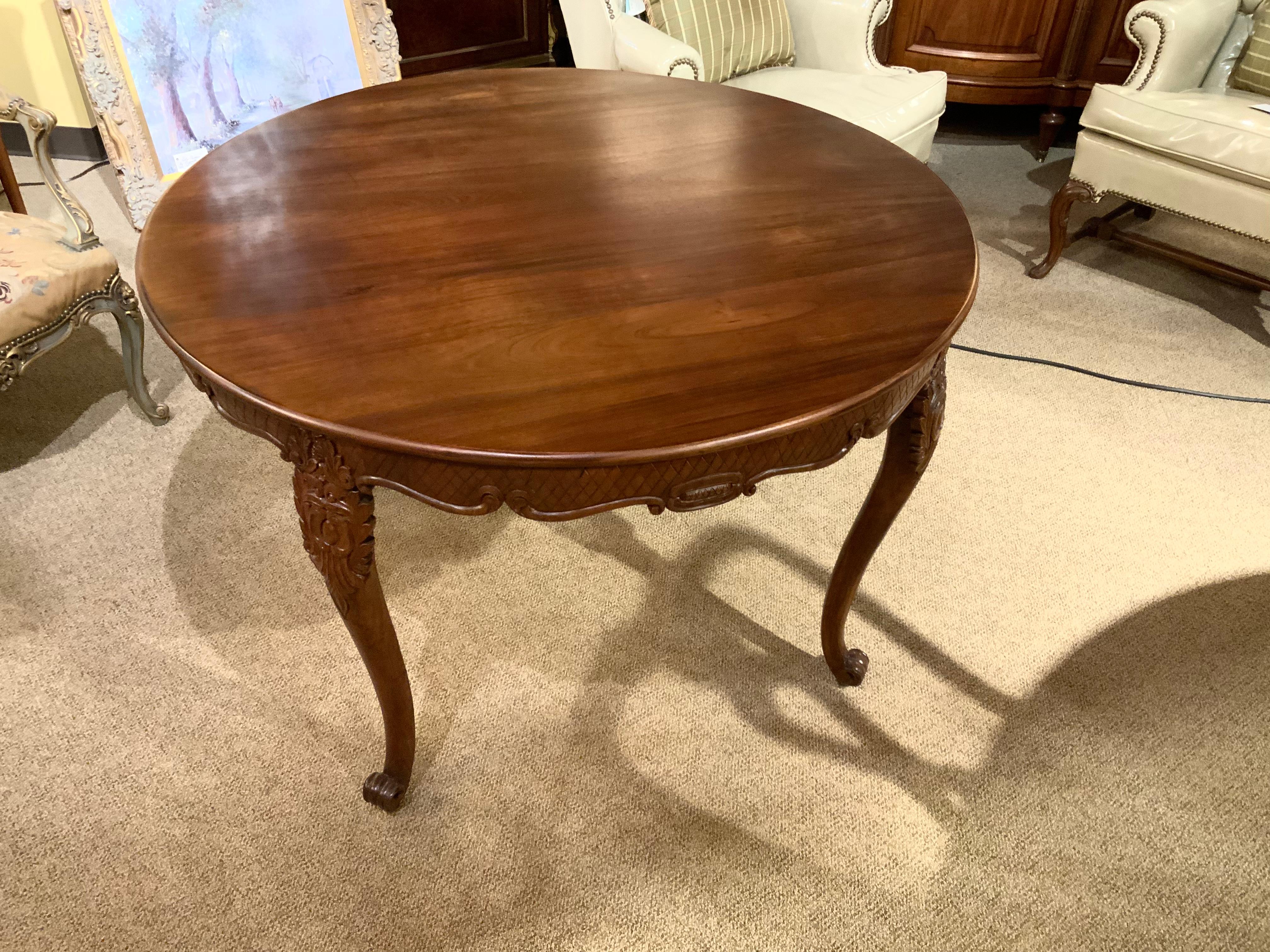 Round Louis V style dining table that has a new finish.
Carved apron with a scalloped shape that has geometric 
Carvings. The legs are gracefully curved and carved with
A lovely design at the top of the leg. The leg ends in
A curled foot. This
