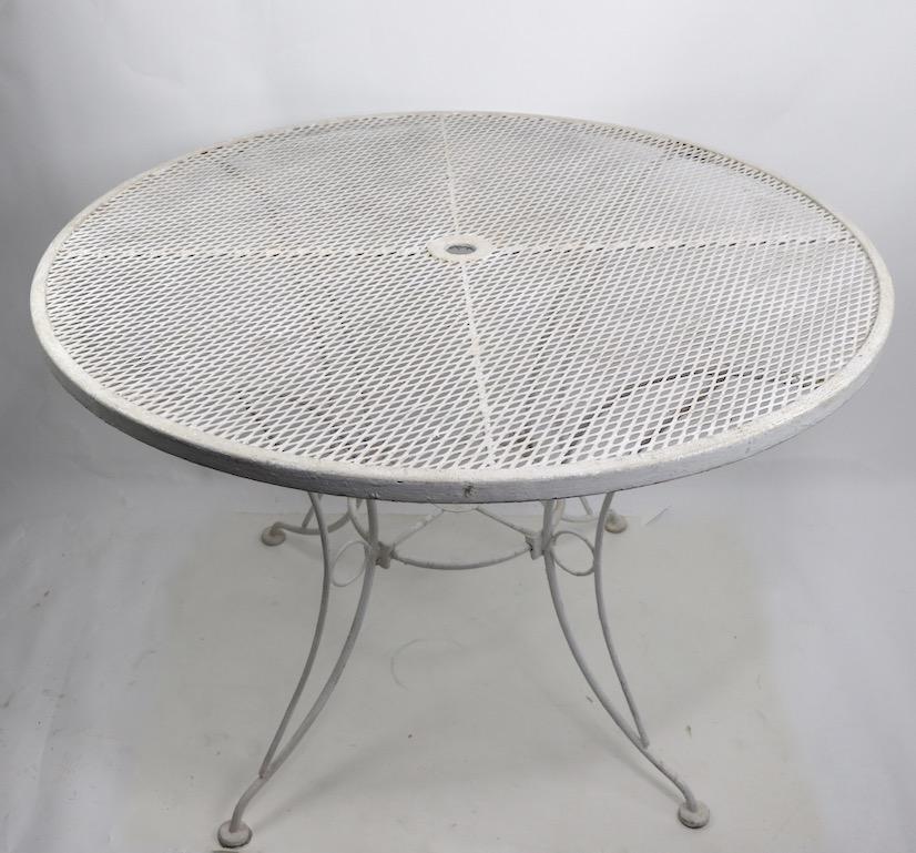 Stylish round garden or patio dining table with wrought and cast iron base, and mesh top. Currently in old white paint finish, usable as is or we offer custom powder coating if you prefer a more polished look.