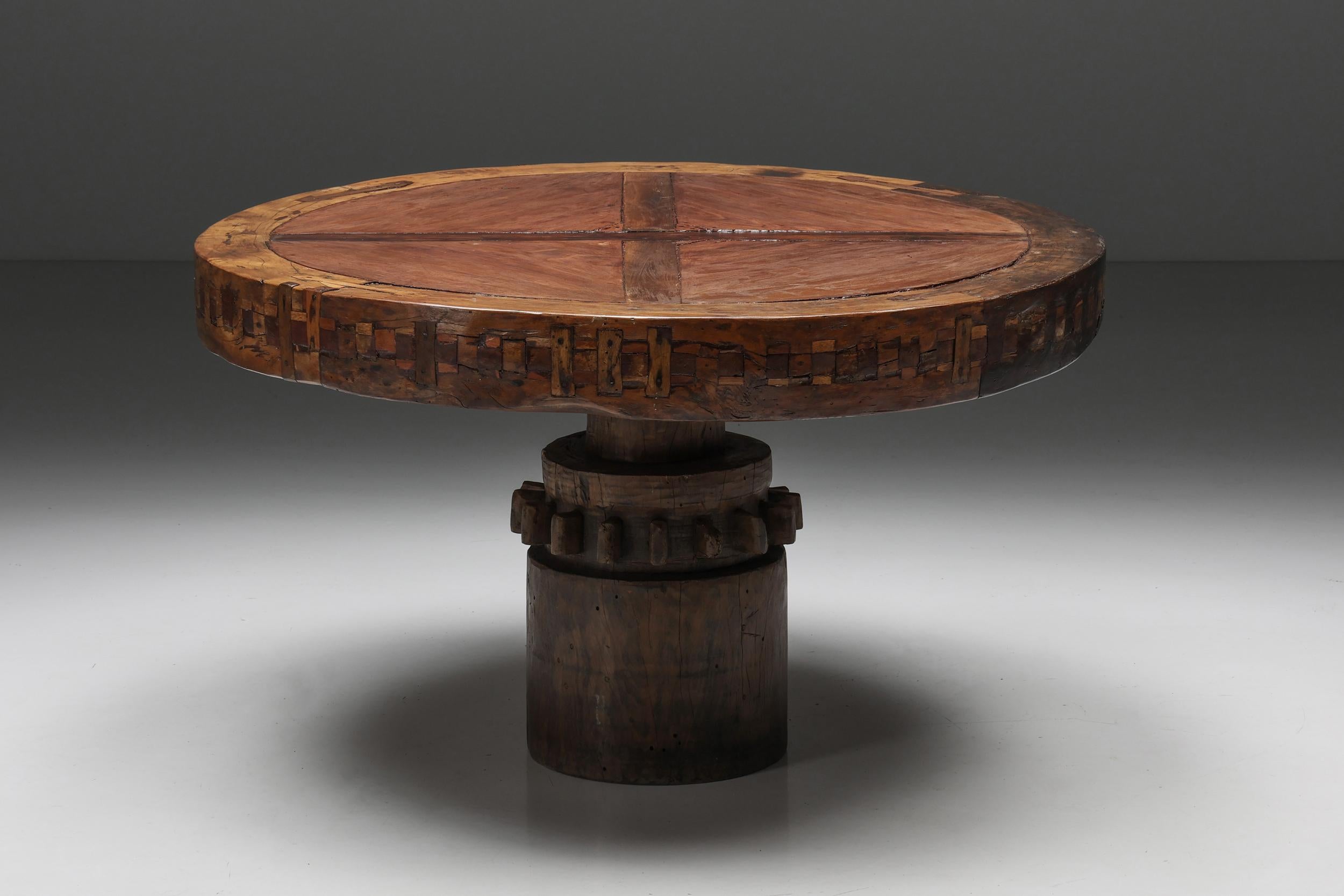 Round; geometric; wooden; dining table; 1950s.

A rare round dining table made of solid wood in a geometric pattern. This robust mid-century modern dining table features a seemingly floating tabletop, resting on a central sturdy base. This