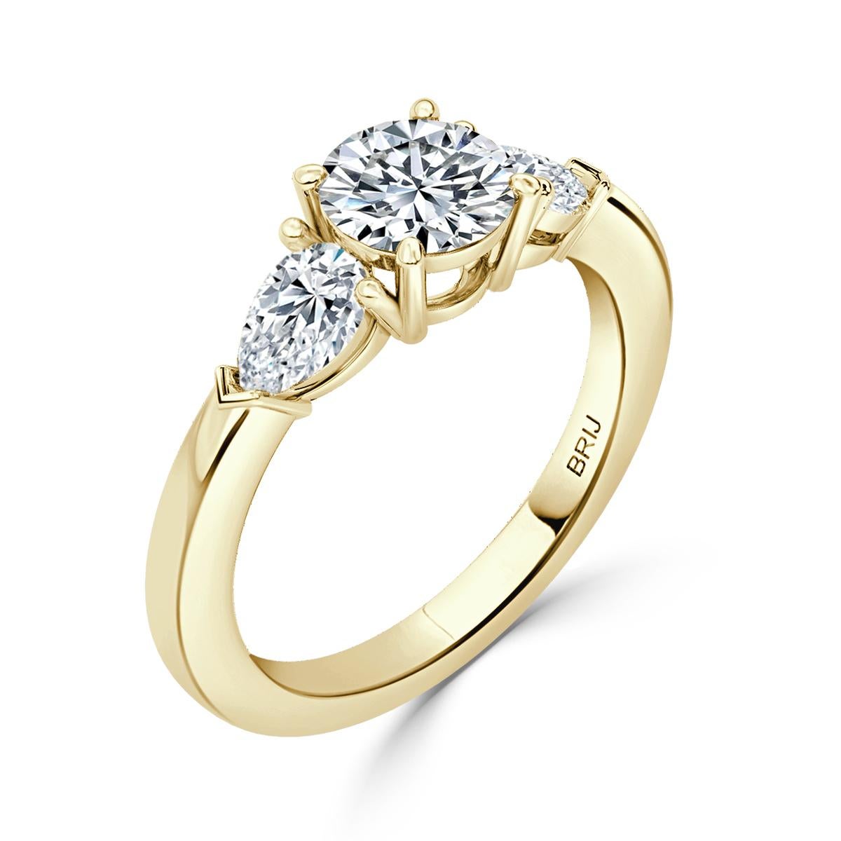 Simple, Classic 3 Stone Diamond engagement ring. Accented with 2 Pear cut GIA Diamonds along the shank  in a 18k Yellow Gold setting. 
GIA certified round center stone 0.80 CT
Side Pear Carat weight 0.60 CT

GIA Certified Diamond Details
Weight: