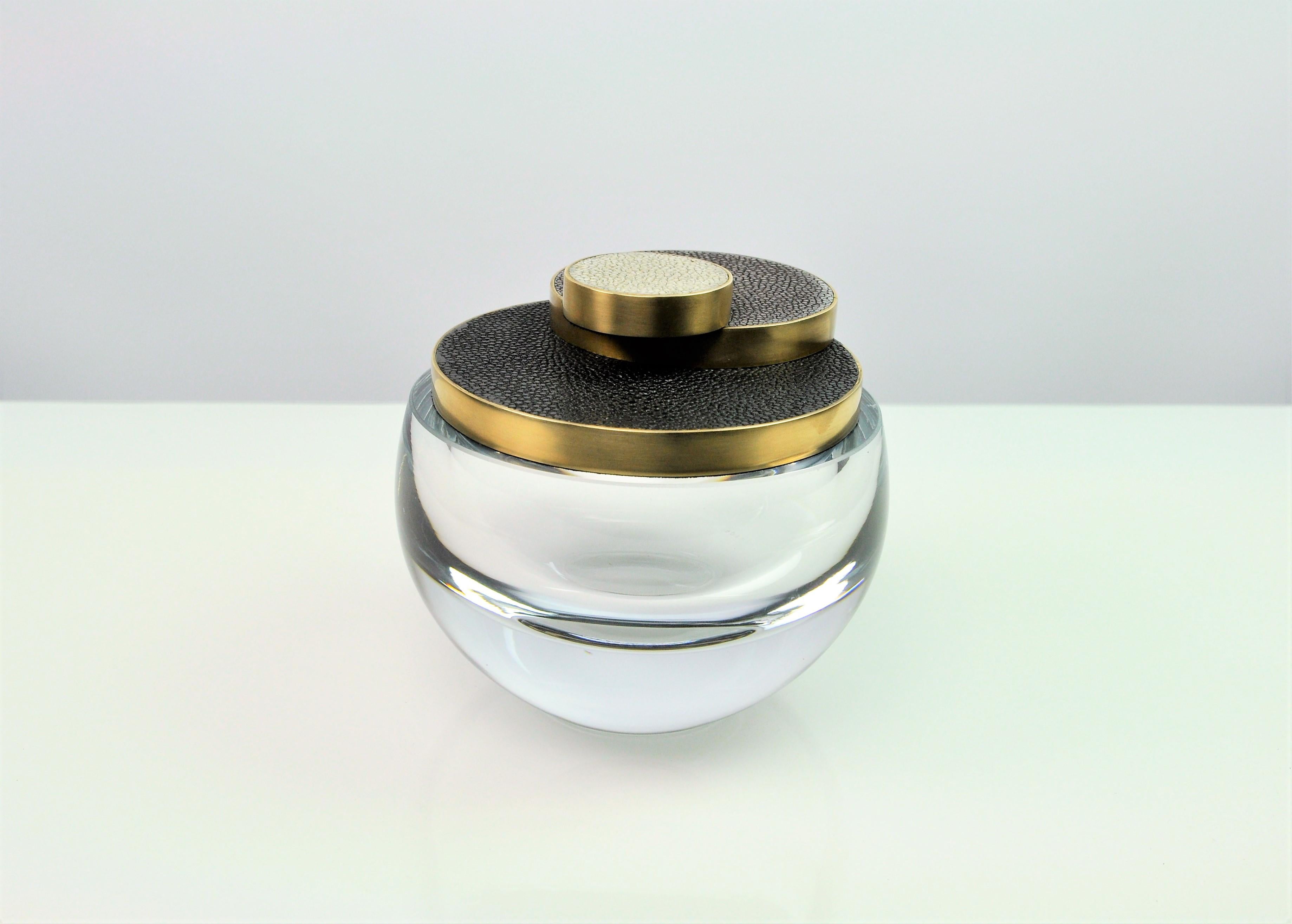 This round glass box has a lid made of shagreen, surrounded with brushed brass trims. 
The circle design decor reminds the great Art deco period with a modern look.
The handmade base is made of a thick glass.

The dimensions of this piece are D