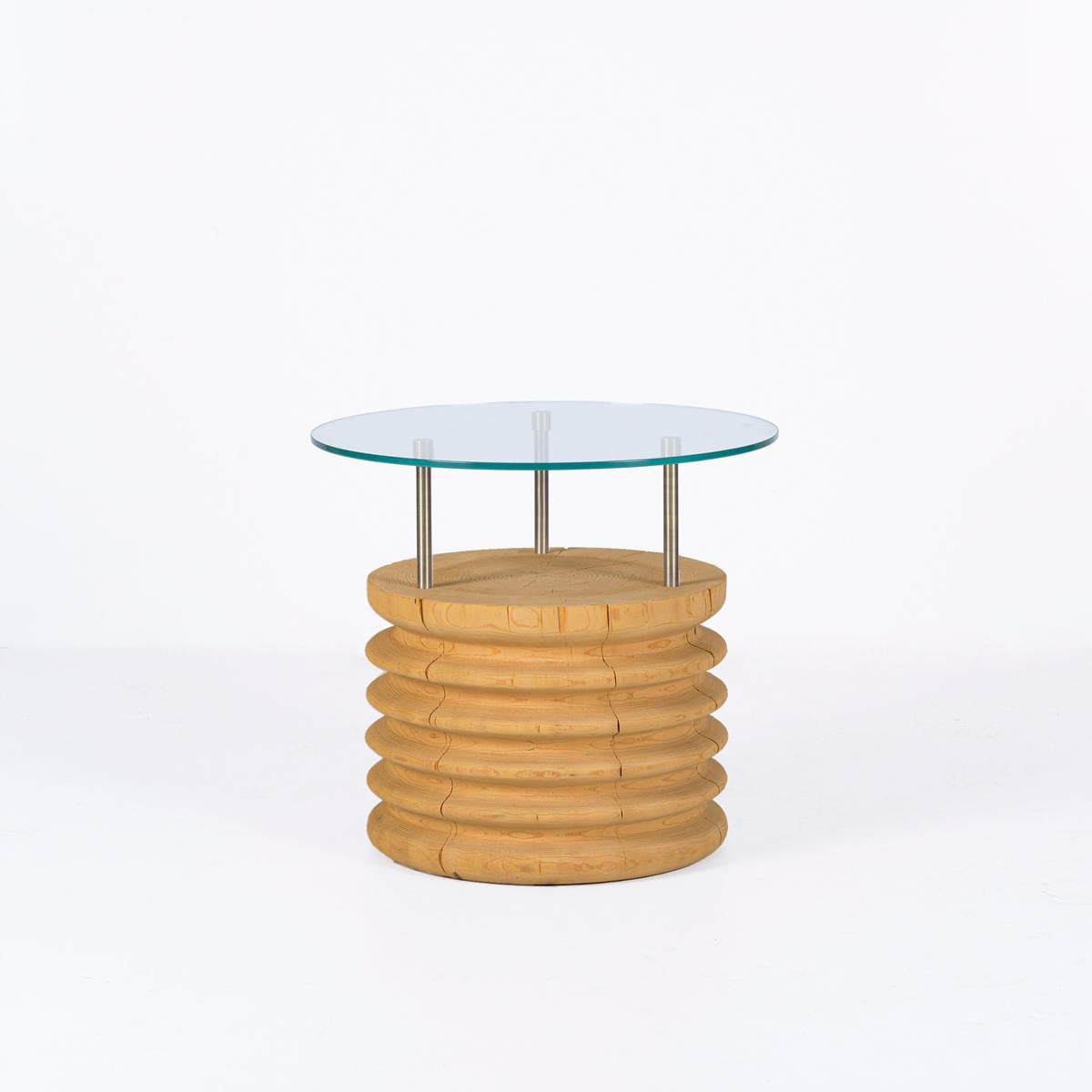 The Round Glass & Cedar Short Side Table – SOFRA Series brings a modern yet natural touch to your living spaces with its elegant and durable design. Featuring a natural cedar wood base and a glass tabletop, this handcrafted solid cedar side table is
