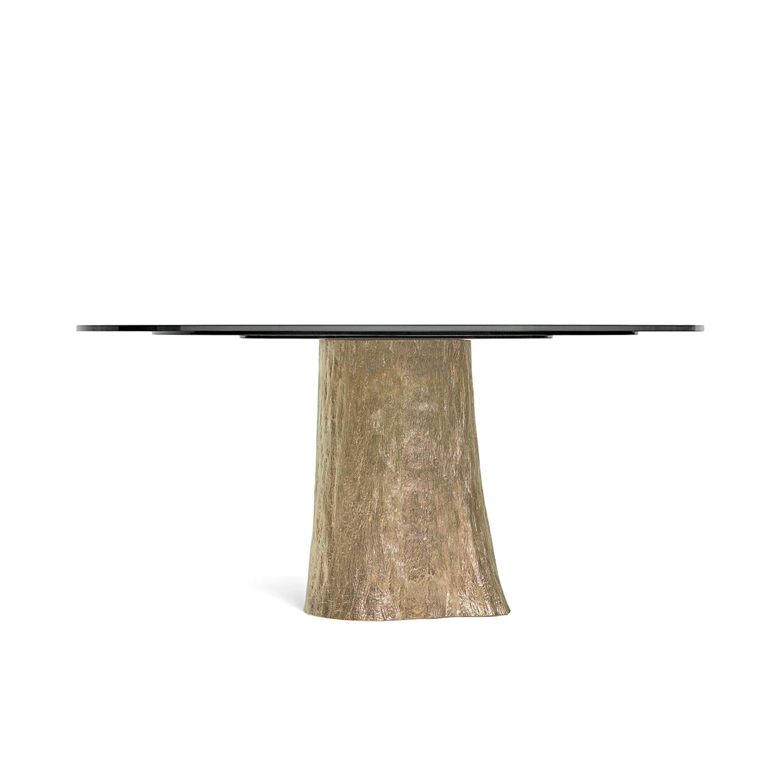 This table represents the vessel of the energy of slow moving waters. They may seem still, but they hold the source of life. The base is made of brass casting of an oak trunk, while the top is composed of three layers of glass, subtly conveying the