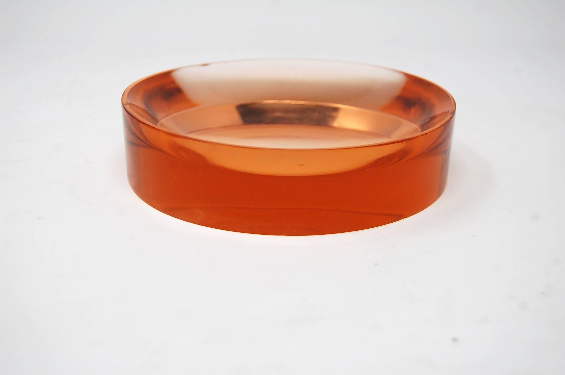 Round glass dish with concave center, attributed to Fontana Arte, circa late 1930s. The color is very difficult to describe, but I would call it somewhere between a pink, and light brown. Measures: 5 3/4