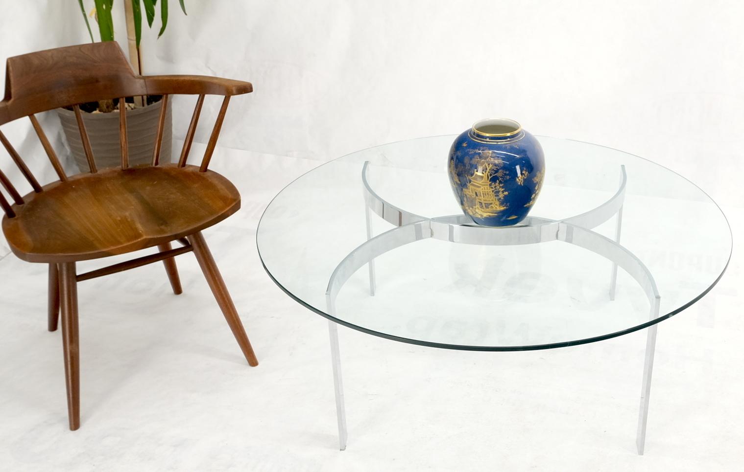 Roundglass top crome interlocking half circle shape figures resembling Chanel logo coffee table.
Bauhaus Mid-Century Modern decor match.