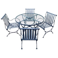 Round Glass Top Iron Patio Table with Four Chairs