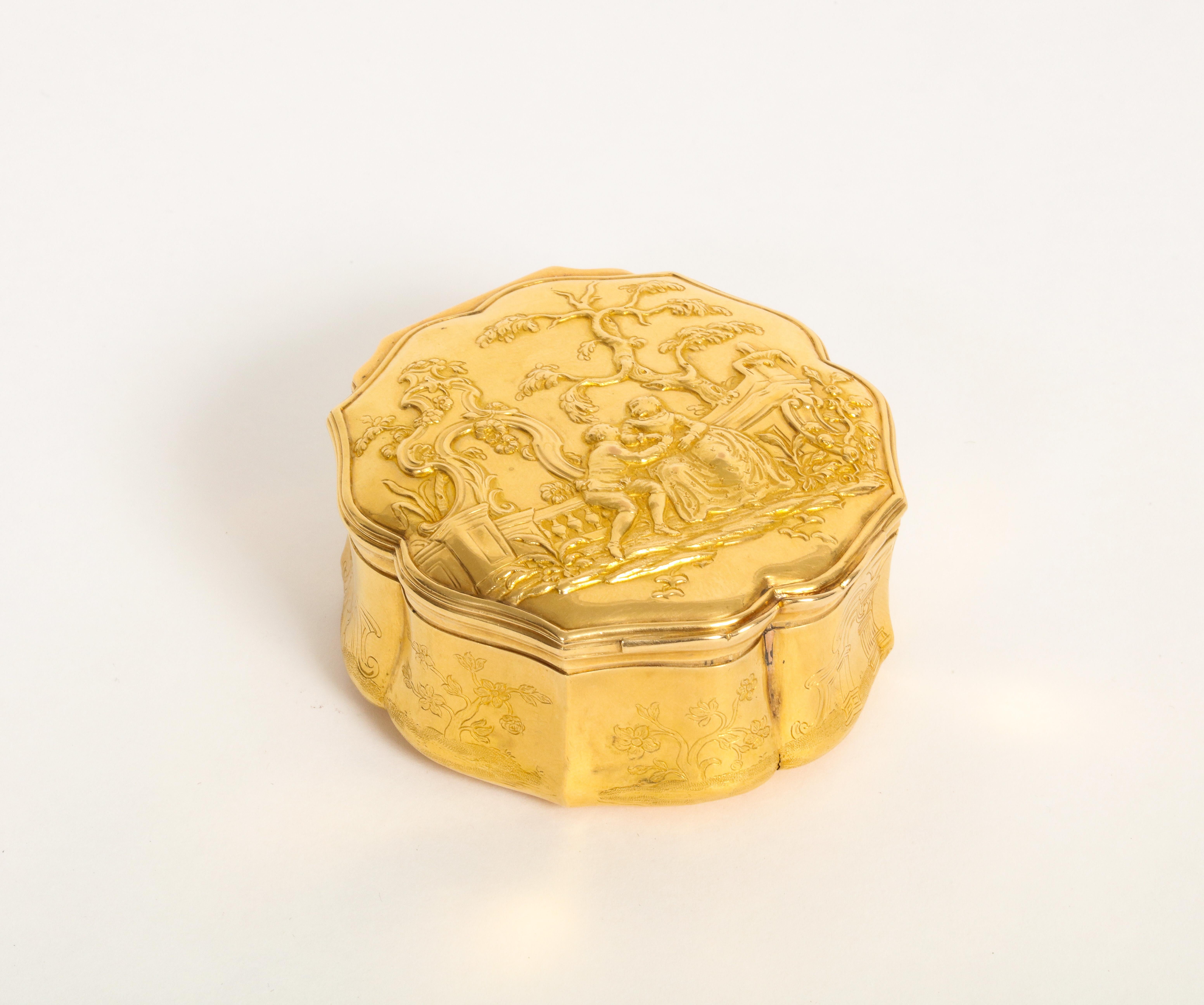Round gold snuff box
Round snuff box in 18k gold, the lid chiseled with a romantic scene on a balustrade background, in the woods landscape, the inside of the lid decorated with a miniature under glass representing an interior scene with characters