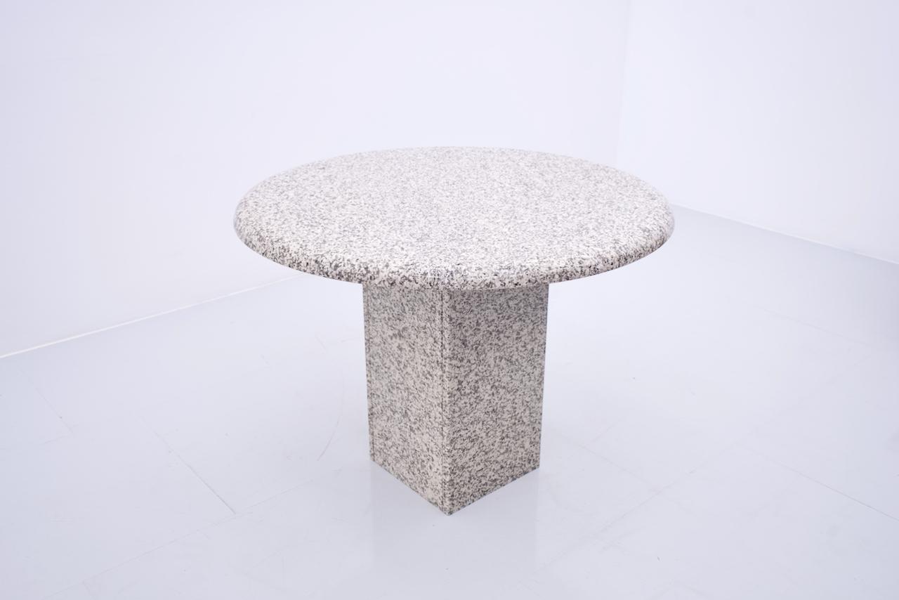 Round granite dining table on a square base. 4 cm thick table top. Very good condition.