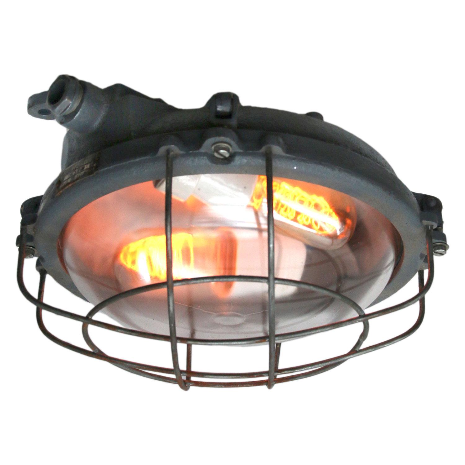 Industrial wall and ceiling scone. Grey cast iron.
Clear glass. Double bulb holder.

Weight: 4.5 kg / 9.9 lb

Priced individual item. All lamps have been made suitable by international standards for incandescent light bulbs, energy-efficient