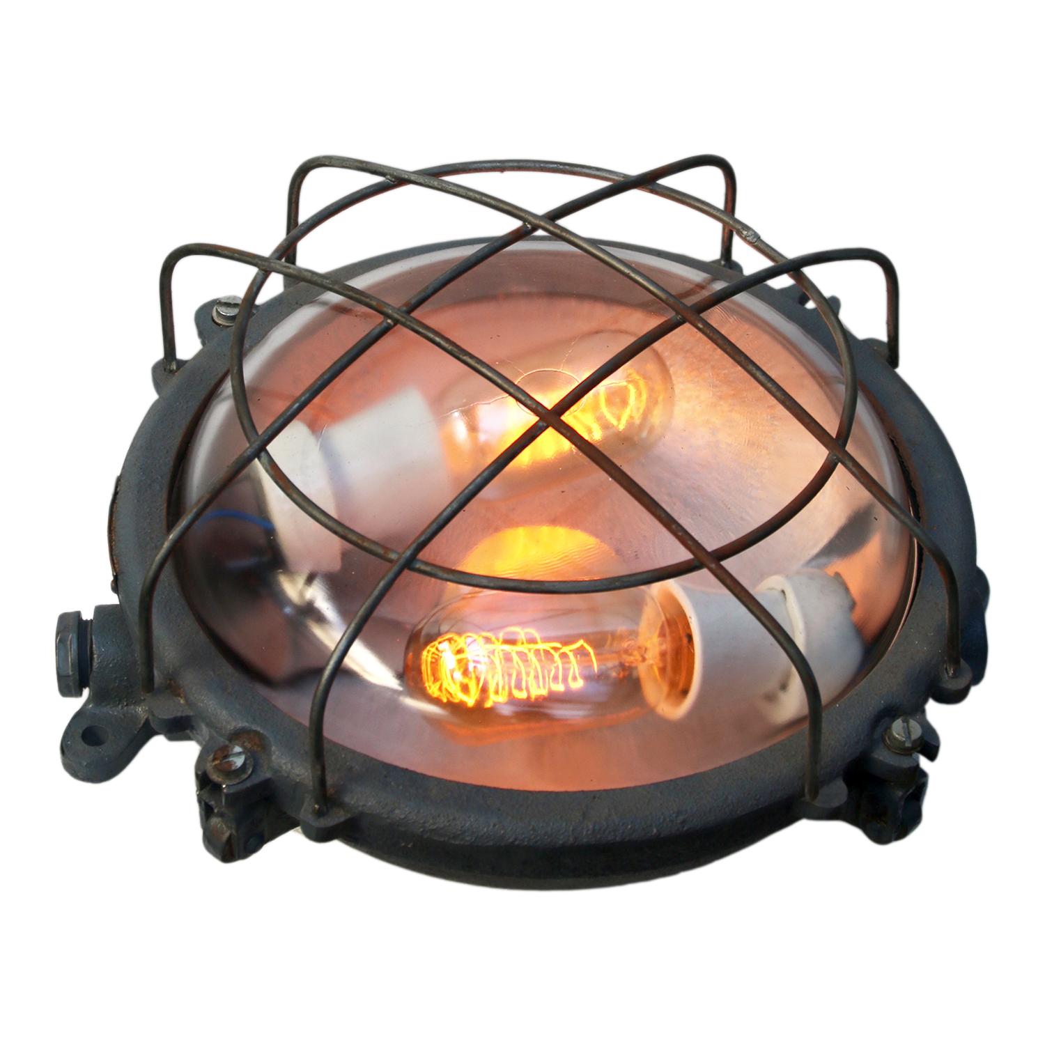 Industrial wall and ceiling scone. Grey cast iron.
Clear glass. Double bulb holder.

Weight: 4.5 kg / 9.9 lb

Priced individual item. All lamps have been made suitable by international standards for incandescent light bulbs, energy-efficient
