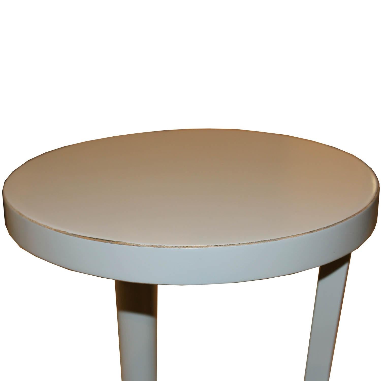 Contemporary small round cocktail table with exposed wood edges can be used as a coffee table or side tables next to an armchair.