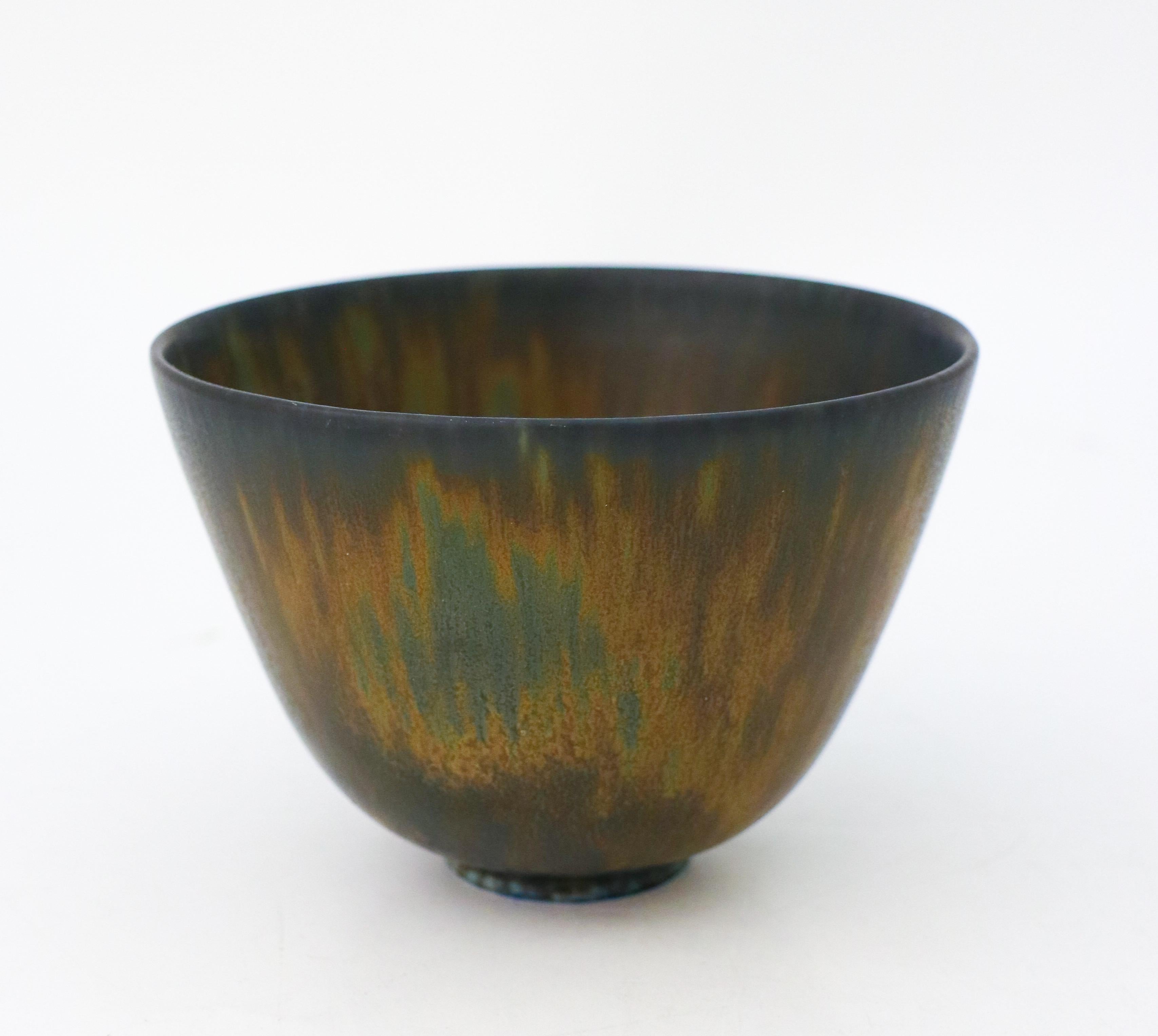 A green and brown bowl designed by Gunnar Nylund at Rörstrand, the bowl is 9 cm (3.6