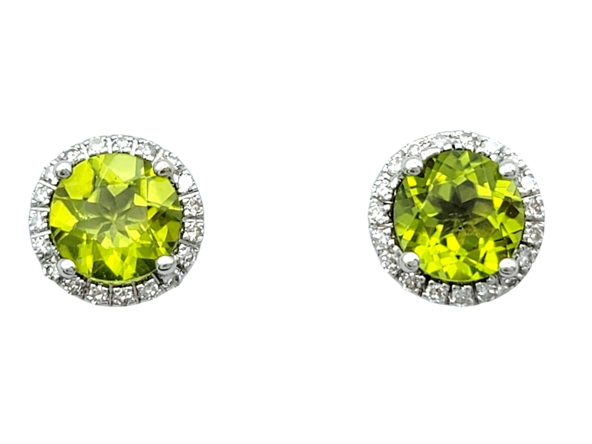 These elegant earrings feature vivid green peridot gemstones encircled by sparkling diamond halos, all set in lustrous 14 karat white gold. The peridot's vibrant hue is complemented by the brilliance of the surrounding diamonds, creating a