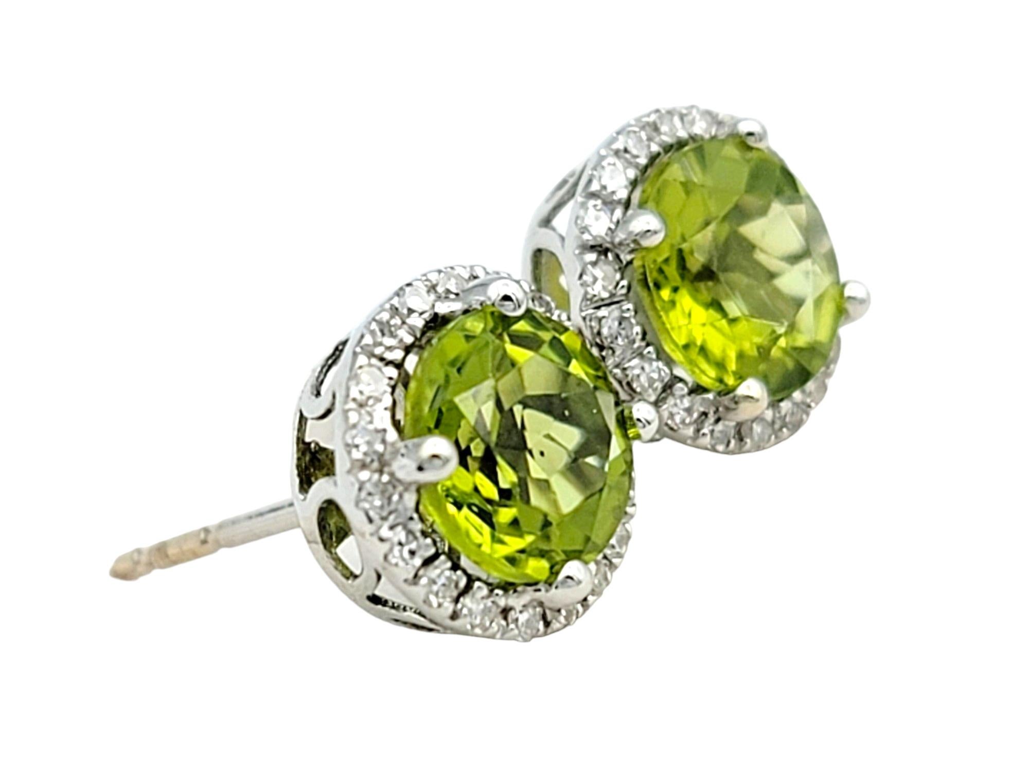 Contemporary Round Green Peridot and Diamond Halo Stud Earrings Set in 14 Karat White Gold For Sale
