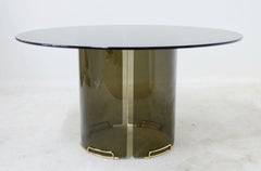 Round Grey Smoky Glass Dining Table with Curved Glass Base and Brass Fittings