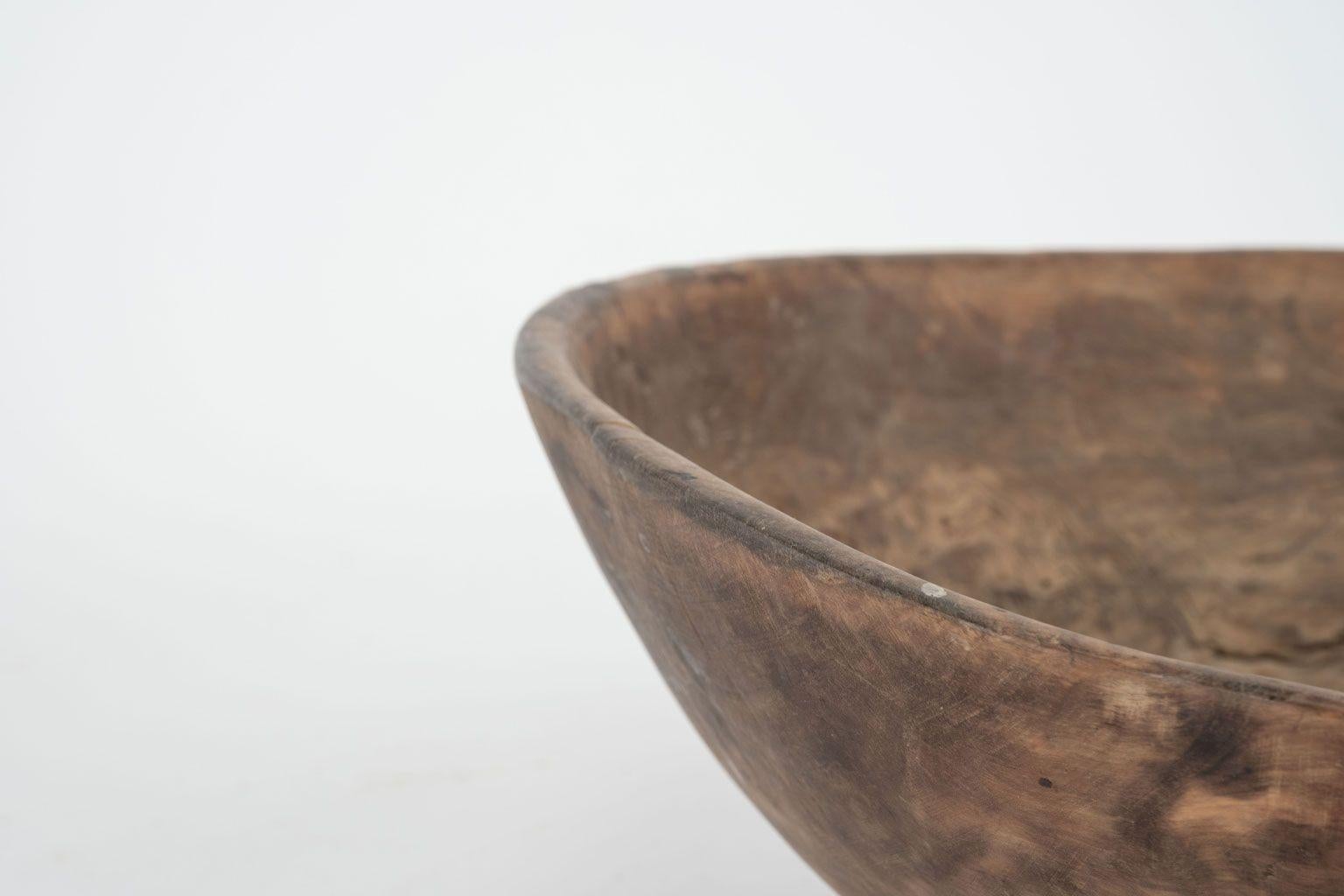 Round hand carved Swedish root wood bowl, dating to 19th century. Retains remnants of early paint, markings and beautiful burled root grain.