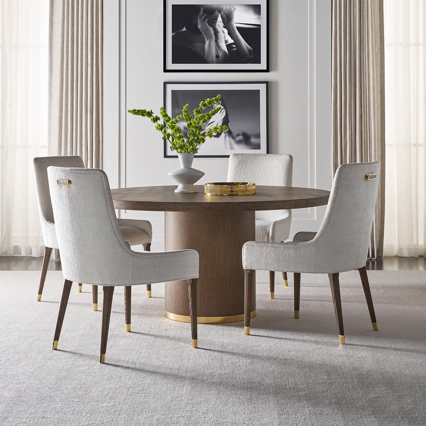 Meticulously designed and beautifully constructed, this round dining table features a dark mink finish that highlights its soft wood grain in a subtle radial pattern. The sleek circular top rests atop a bold cylindrical pedestal base, accented by a