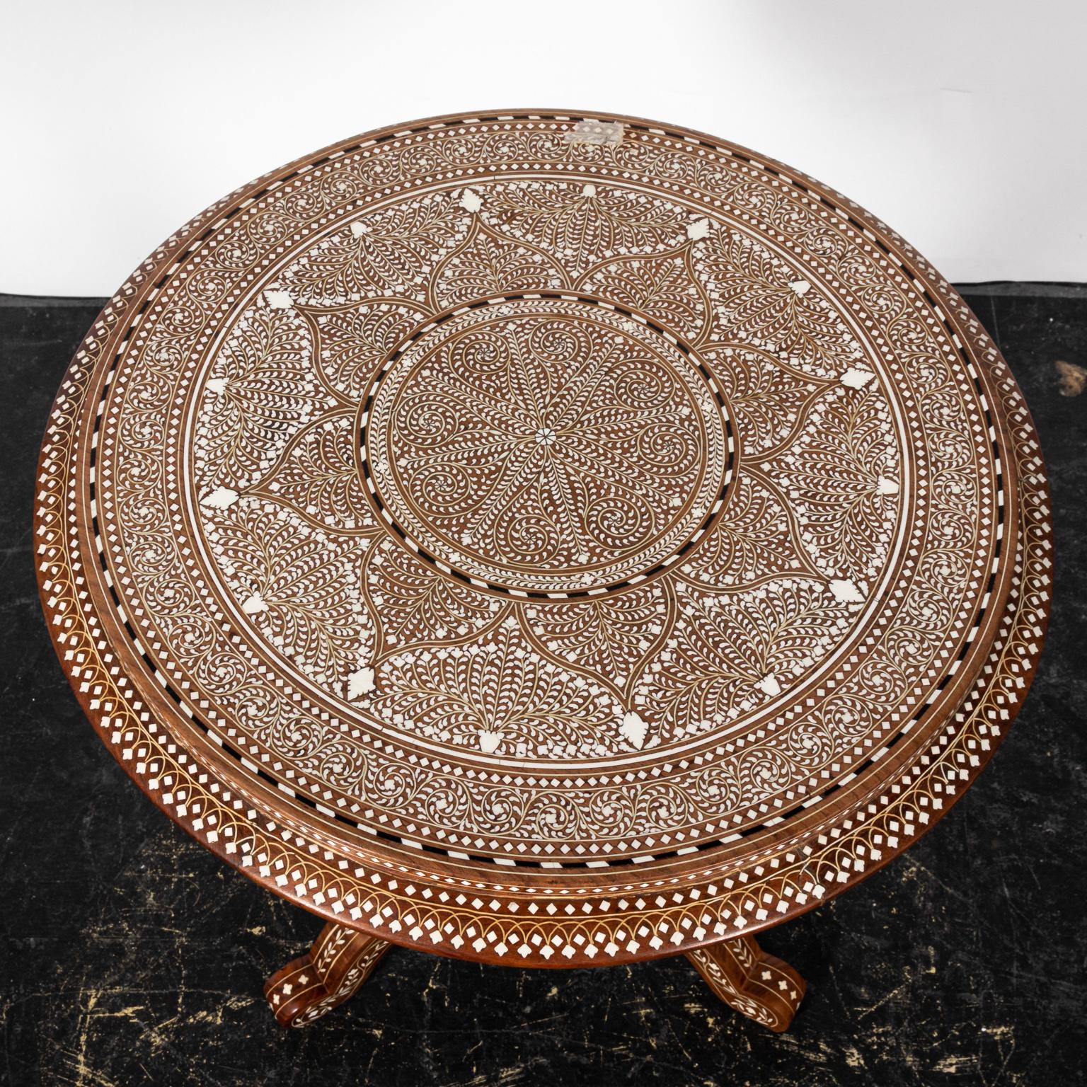 Round wood pedestal side table with bone inlay. Please note of wear consistent with age.

  