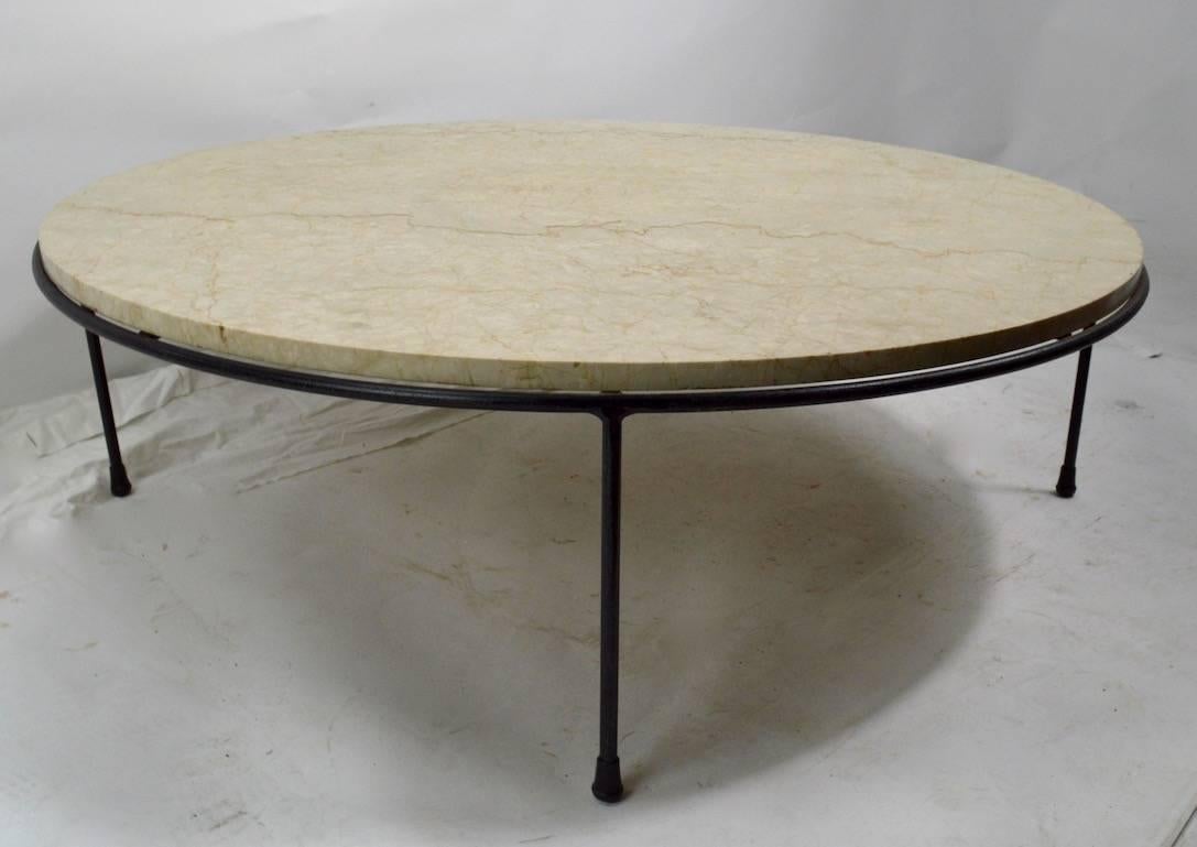 Rare iron and marble coffee table designed by Paul McCobb. Wrought iron base supports marble disk top, table shows minor cosmetic wear, normal and consistent with age. This is a hard to find item, chic, sophisticated architectural form, untouched