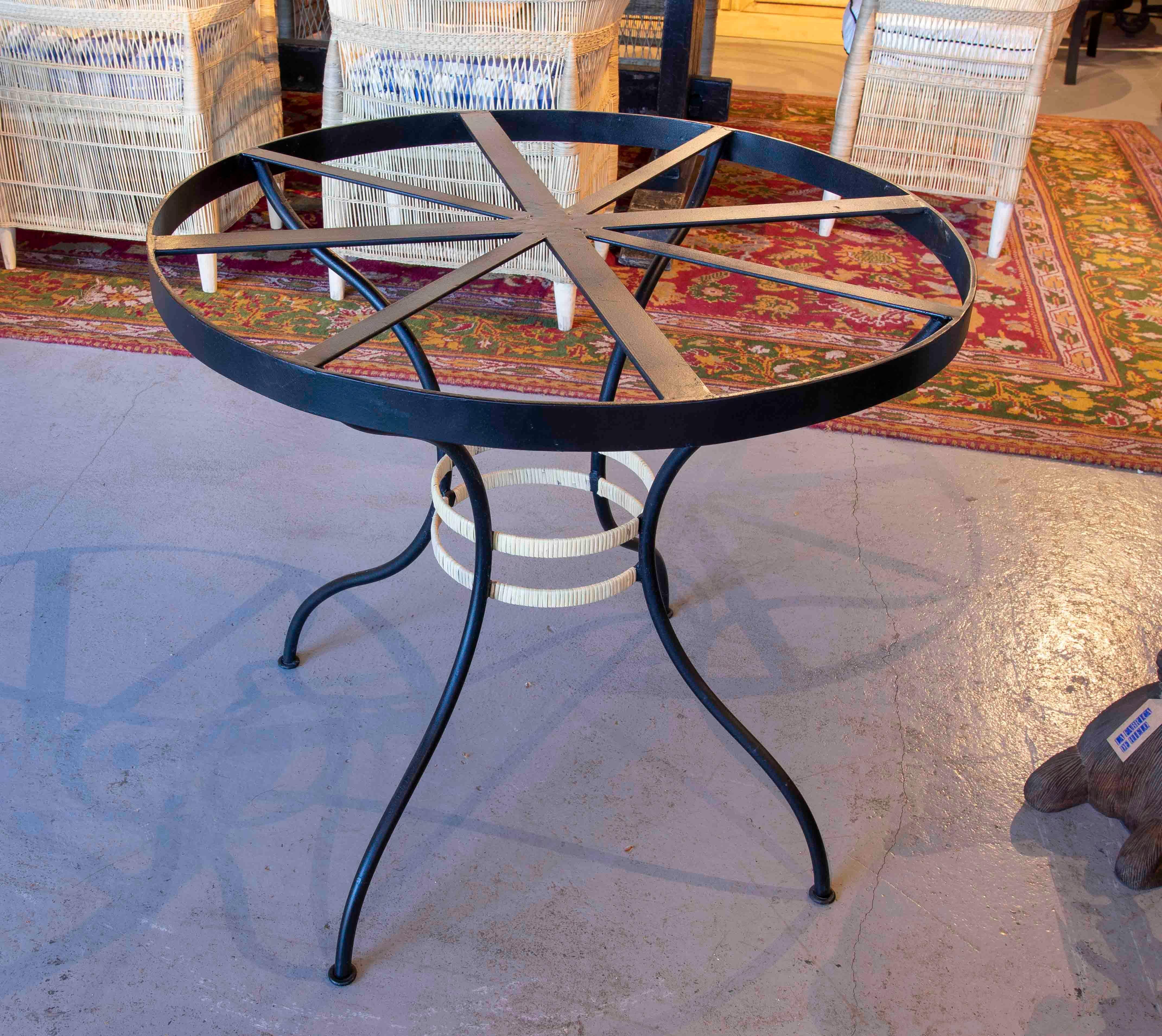 Round Iron Table with Wicker Decoration on the Base.