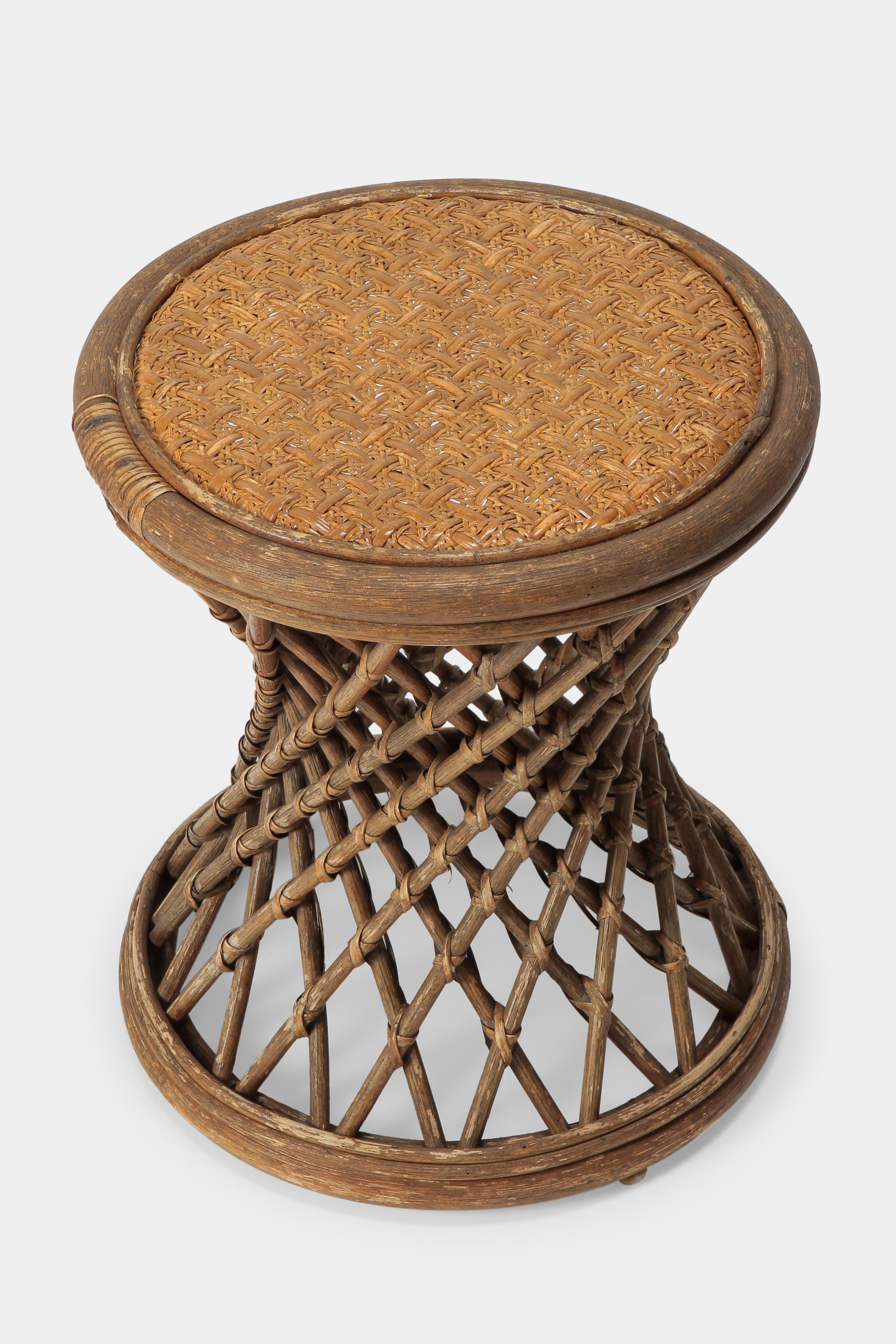 Beautifully woven round stool made of rattan and bamboo with a unique base, from Italy, 1950. Can be used as a stool, side table, nightstand or small coffee table. The stool has been cleaned and restored.