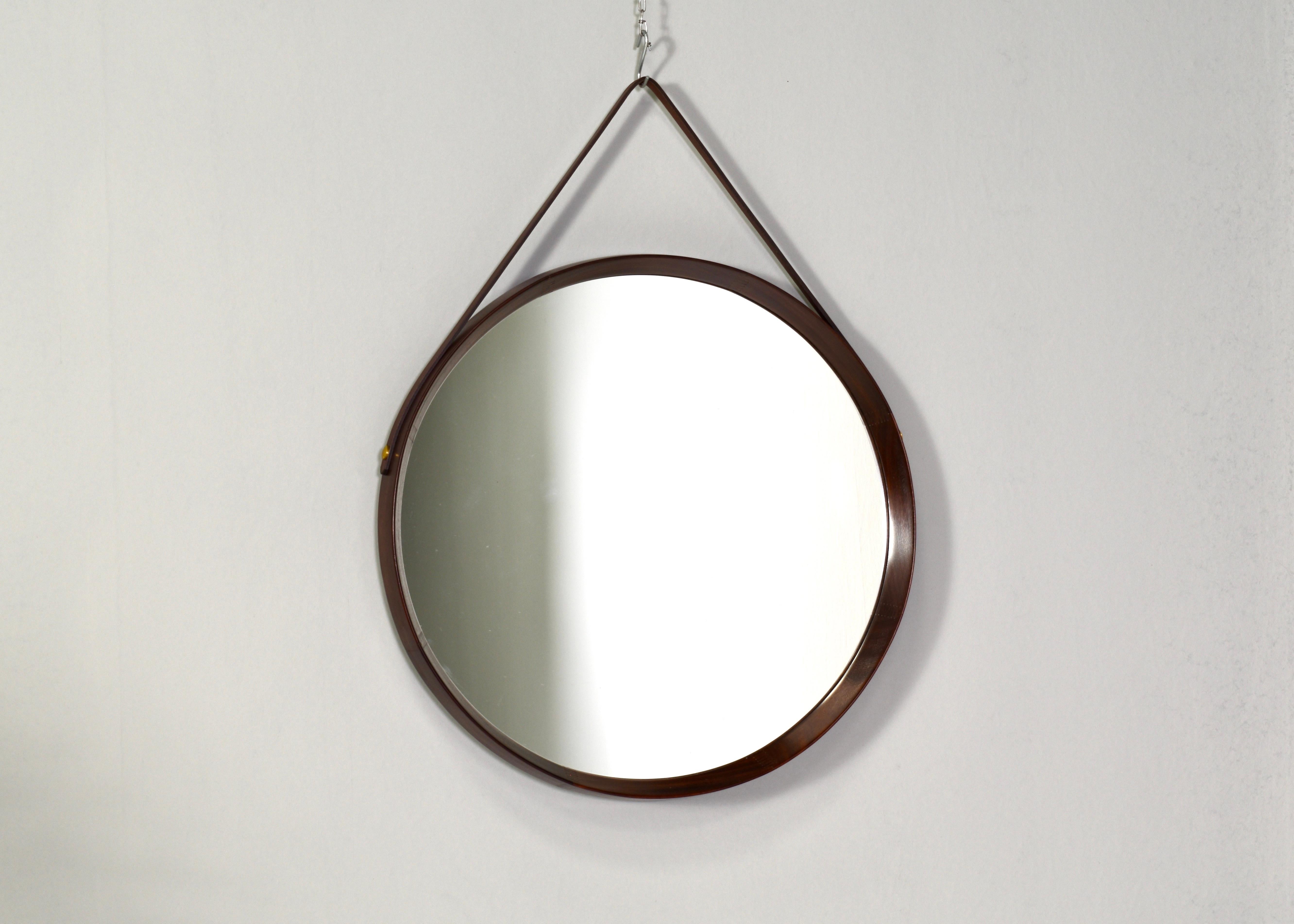Round Italian teak mirror – 1950s. Amazing Italian design; the round tapered edge is made out of one piece of solid teak wood. The mounting strap is made of leather and is attached with brass screws. In very good condition.

Designer: